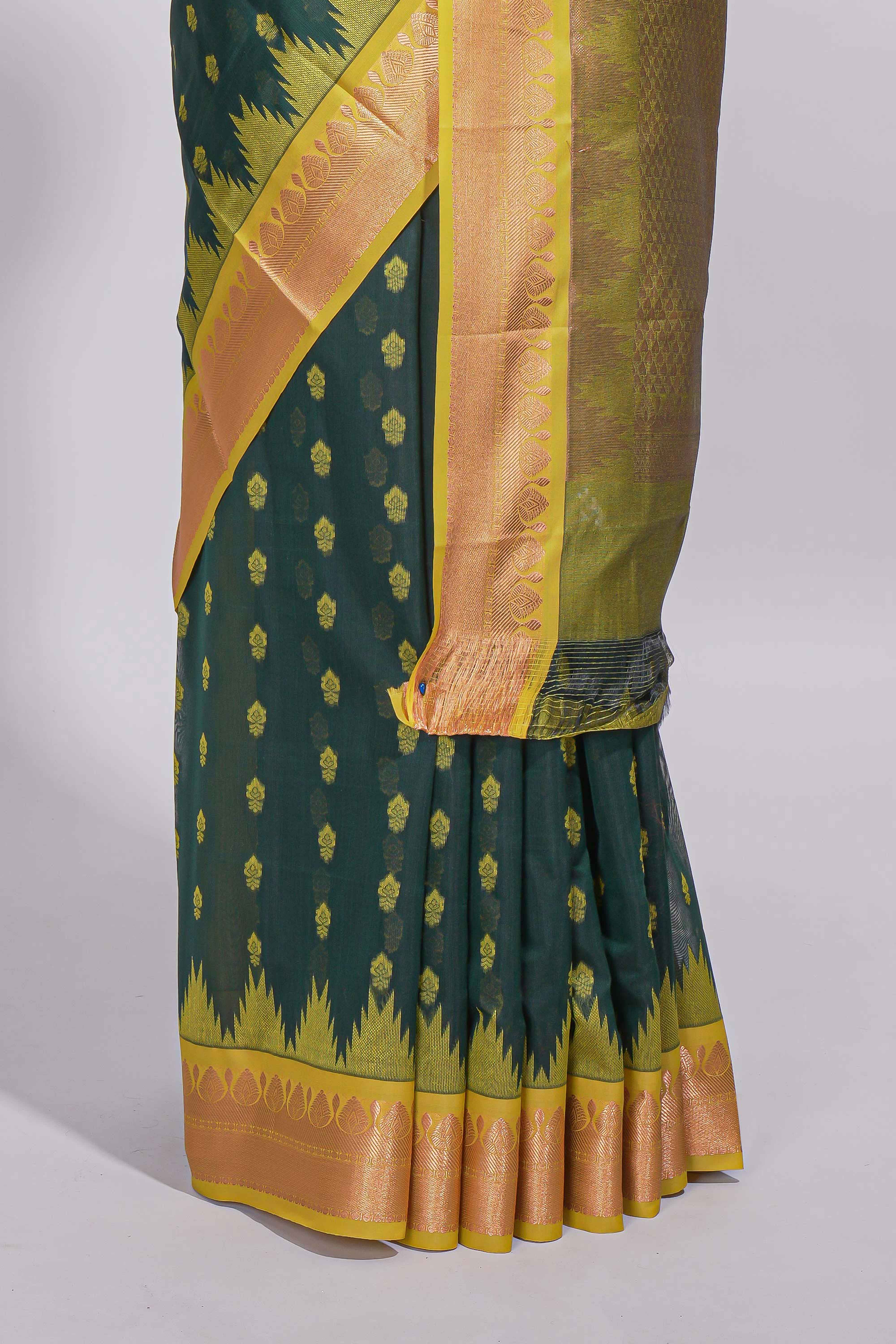 Dark teal green kotta cotton with gold zari buttas a zari border with temple design and zari woven pallu with matching blouse piece