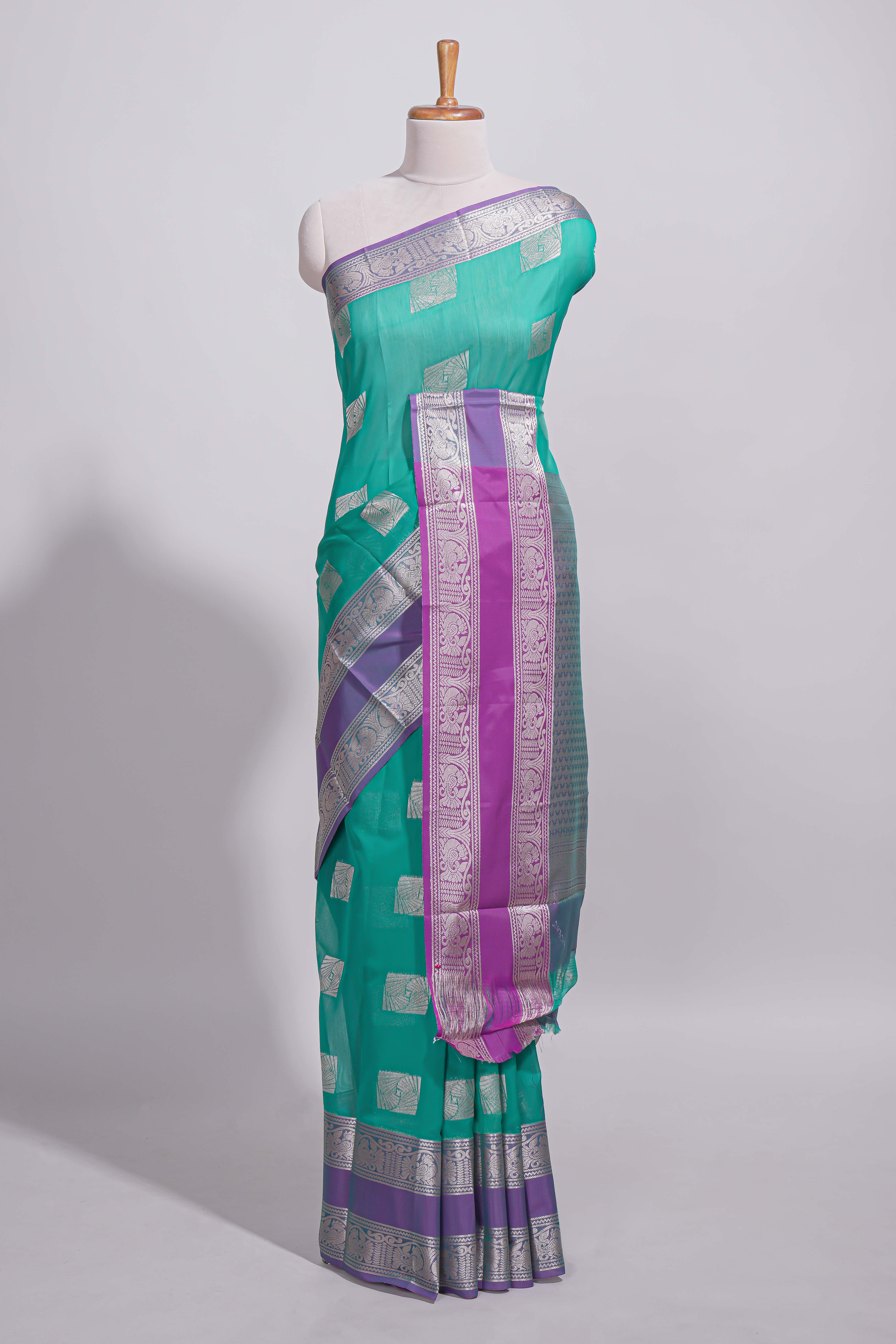 Rama green tussar saree with silver zari square buttas retta petta zari border and woven zari pallu with contrast blouse piece