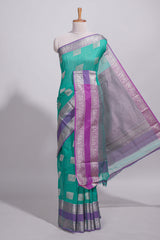 Rama green tussar saree with silver zari square buttas retta petta zari border and woven zari pallu with contrast blouse piece