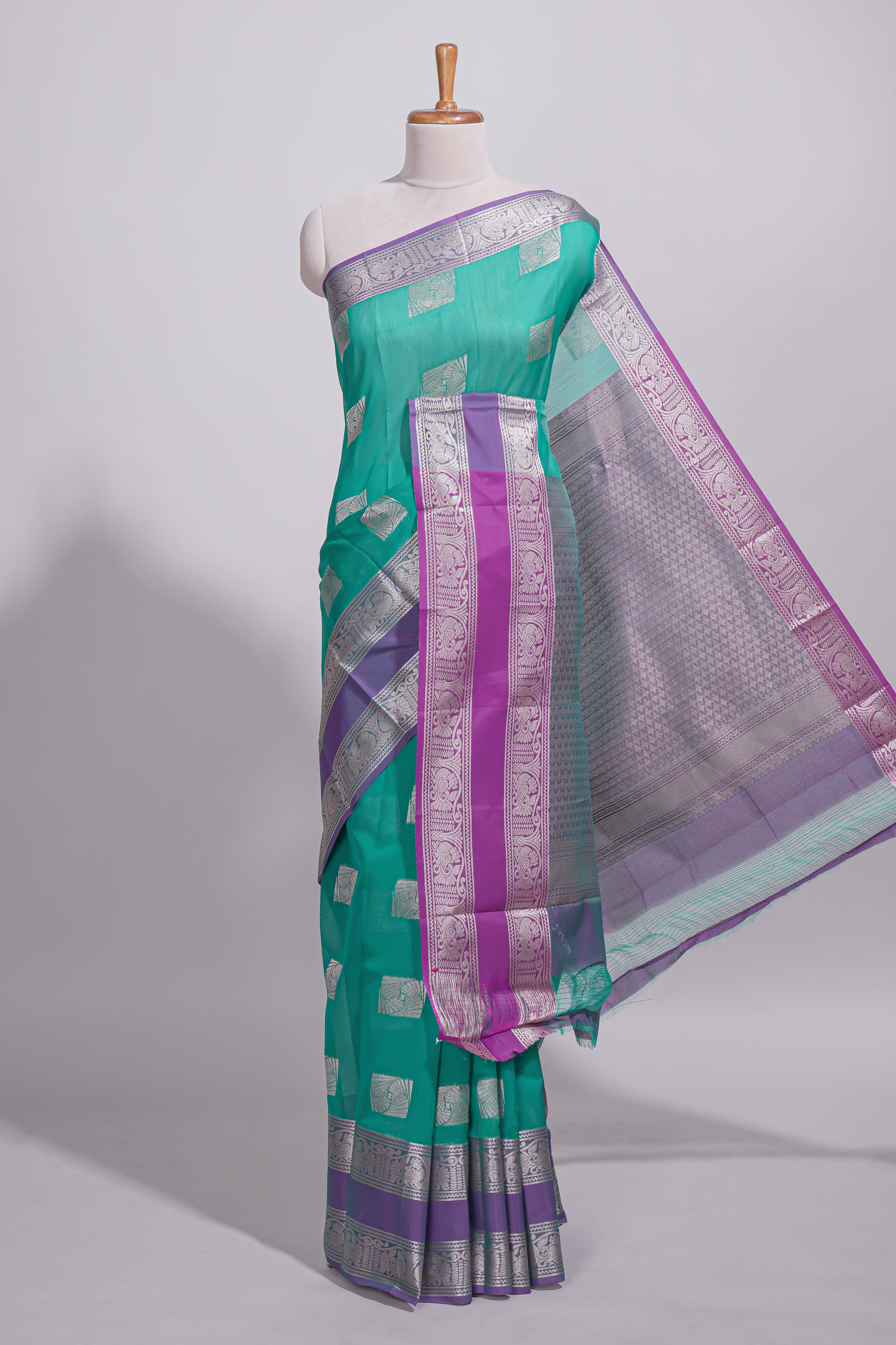 Rama green tussar saree with silver zari square buttas retta petta zari border and woven zari pallu with contrast blouse piece