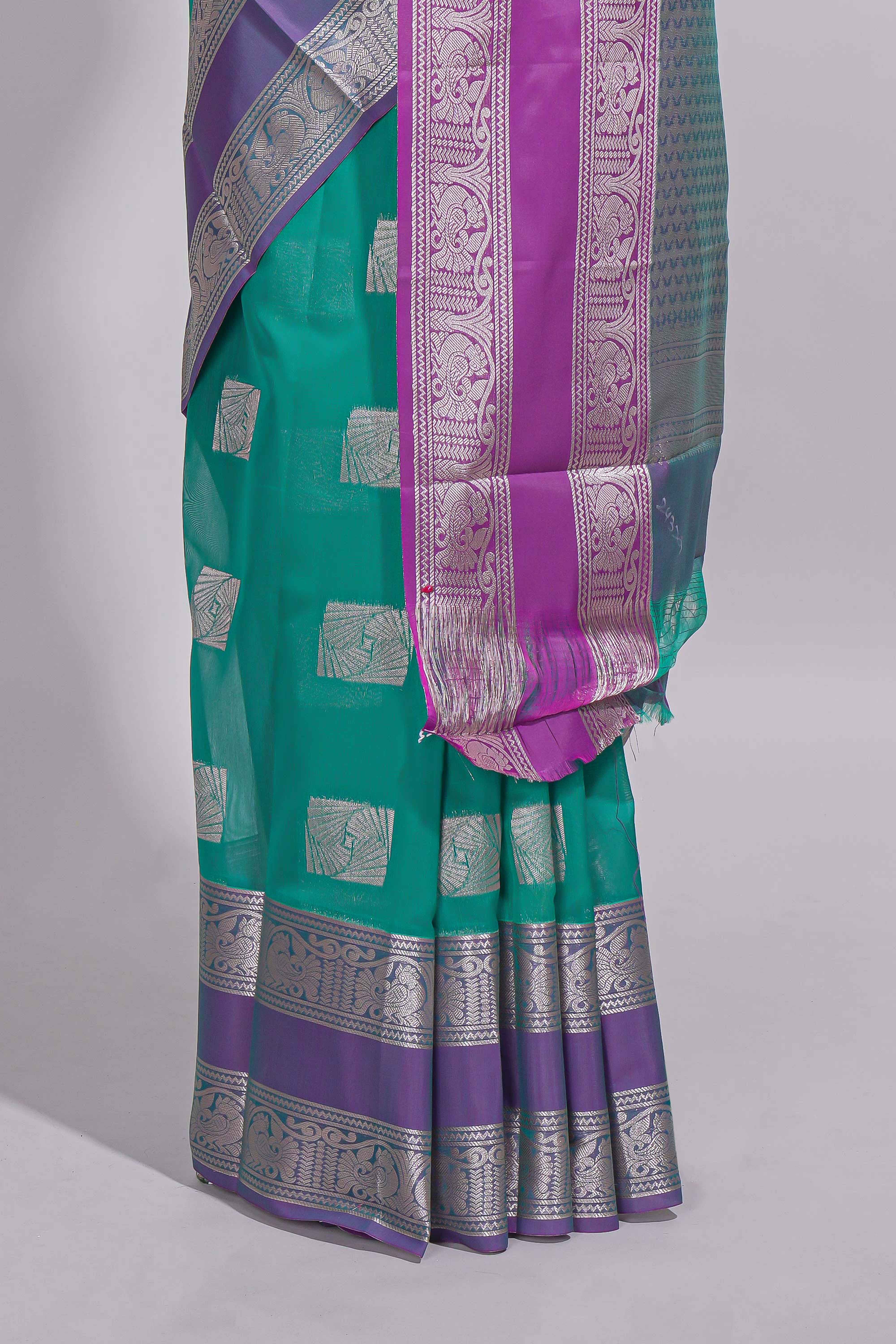 Rama green tussar saree with silver zari square buttas retta petta zari border and woven zari pallu with contrast blouse piece