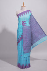 Sky blue Kotta cotton saree with woven buttas contrasting purple Ikat-inspired border and a geometric woven pallu with matching blouse