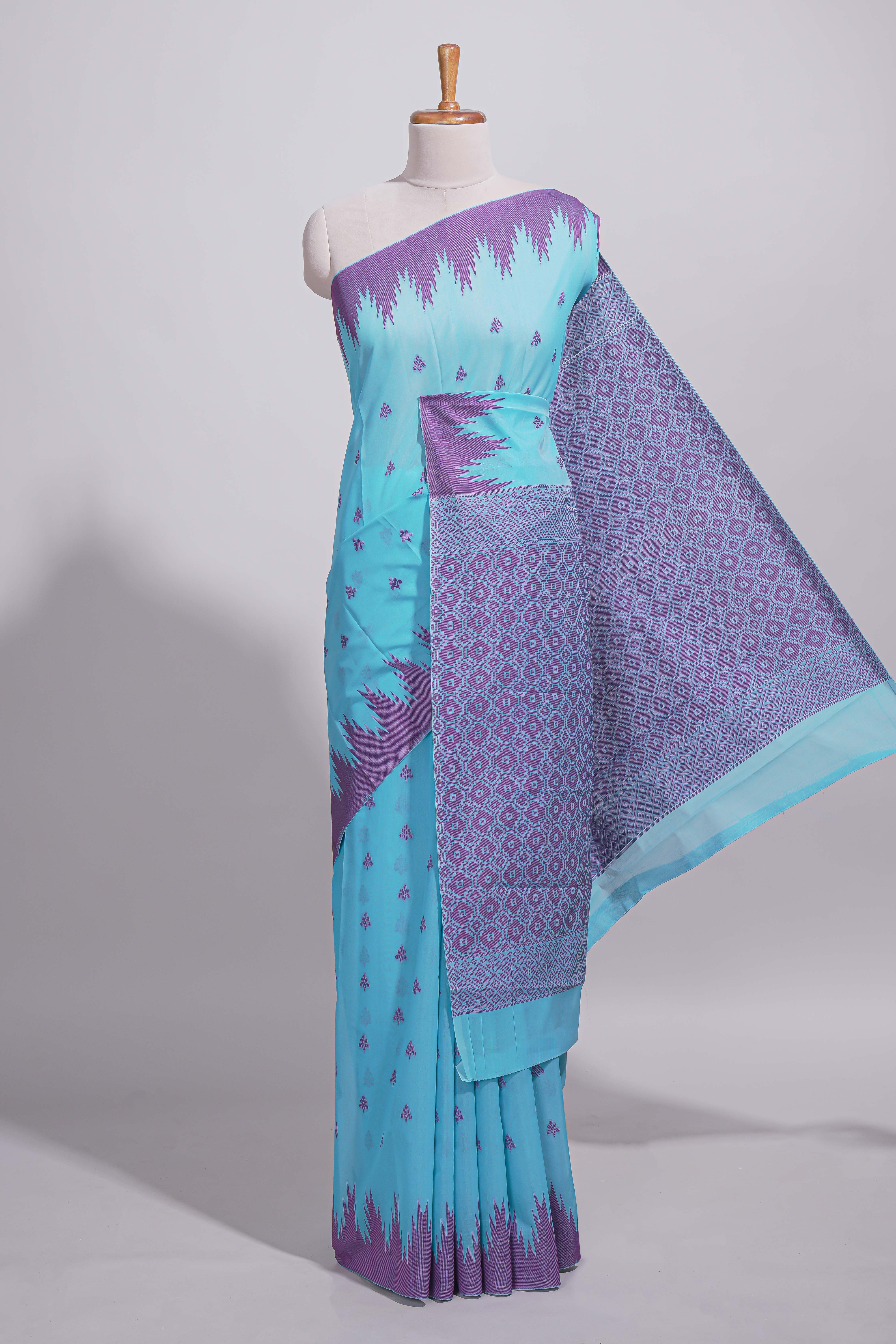 Sky blue Kotta cotton saree with woven buttas contrasting purple Ikat-inspired border and a geometric woven pallu with matching blouse