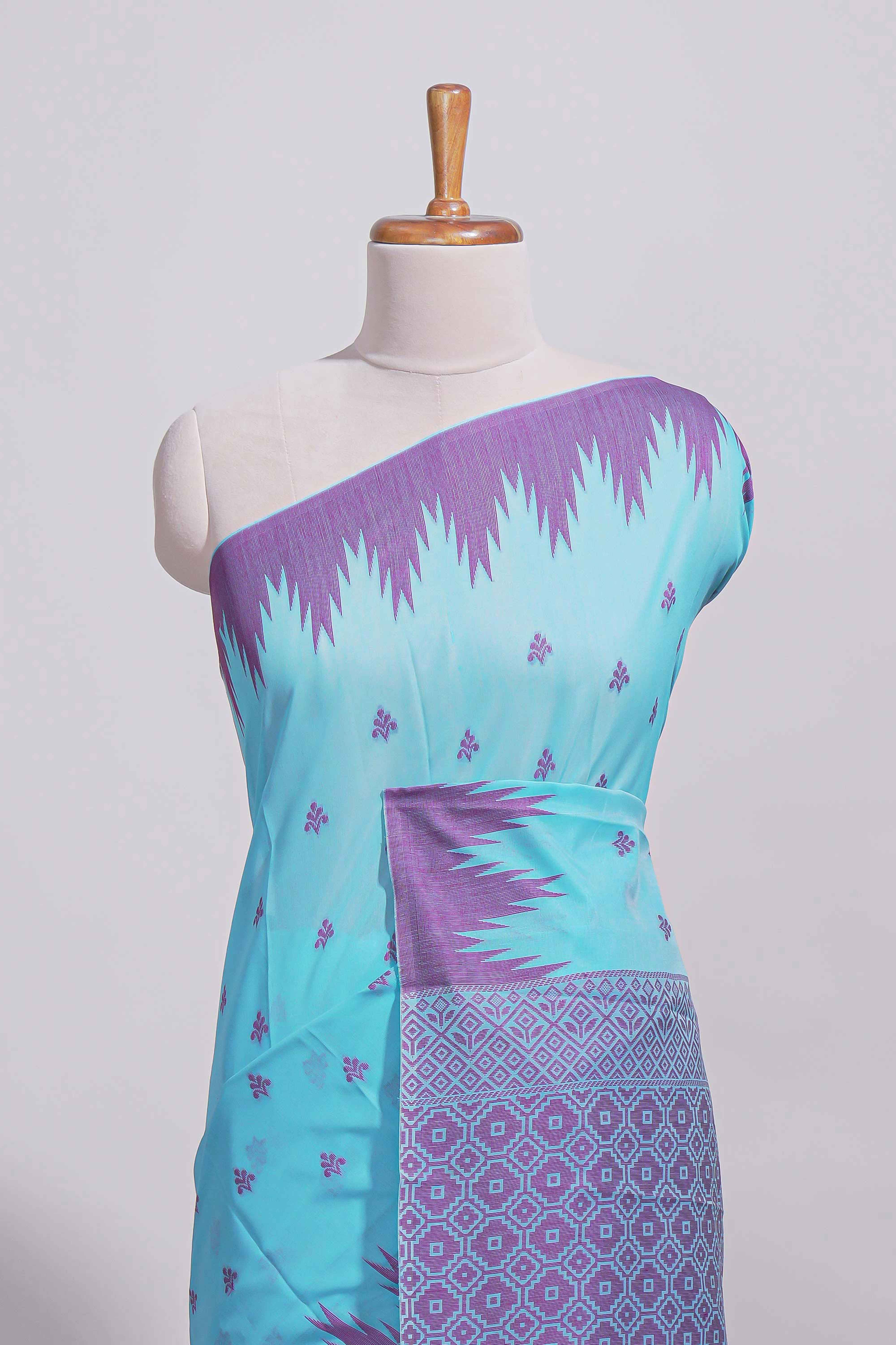 Sky blue Kotta cotton saree with woven buttas contrasting purple Ikat-inspired border and a geometric woven pallu with matching blouse