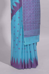 Sky blue Kotta cotton saree with woven buttas contrasting purple Ikat-inspired border and a geometric woven pallu with matching blouse