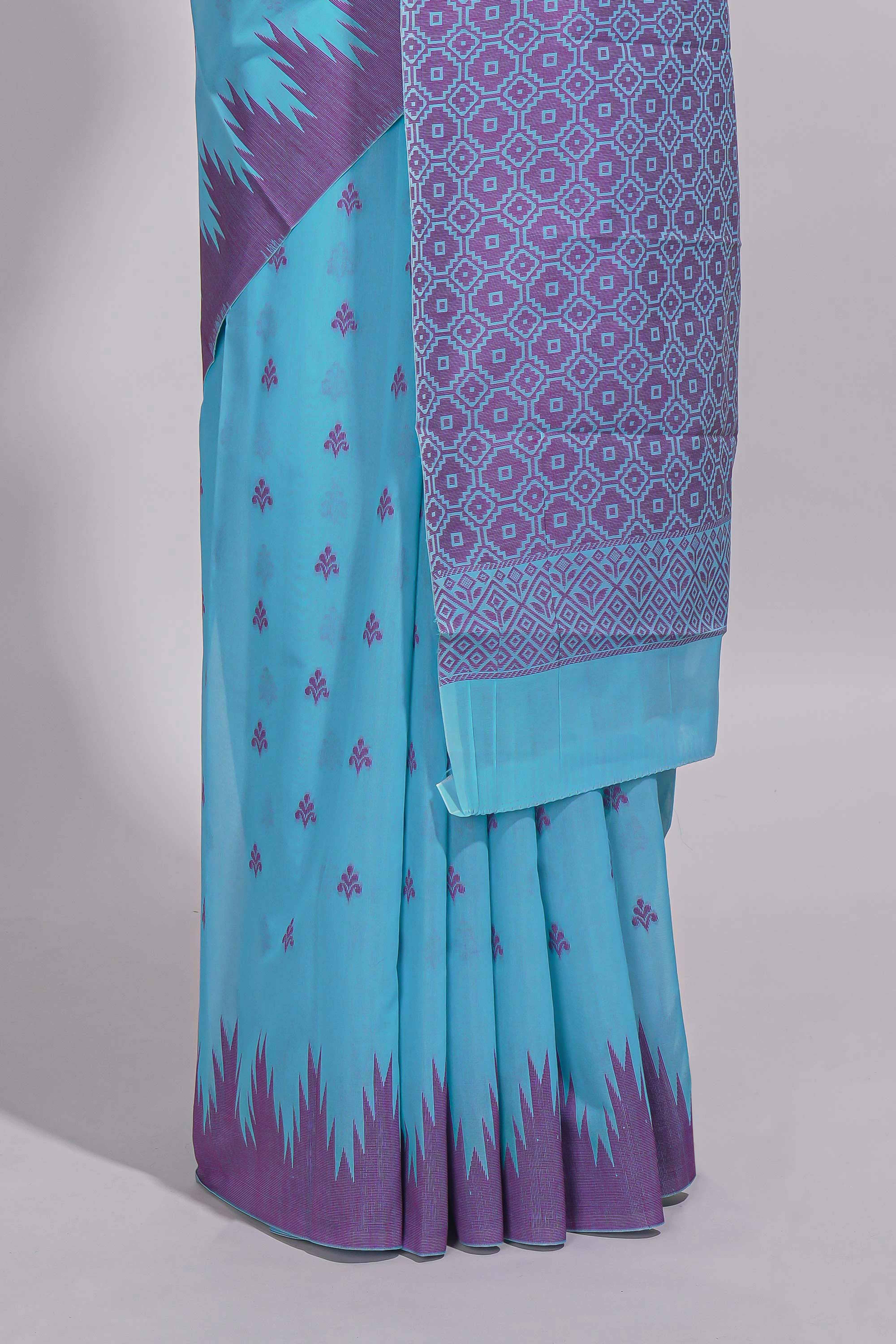 Sky blue Kotta cotton saree with woven buttas contrasting purple Ikat-inspired border and a geometric woven pallu with matching blouse