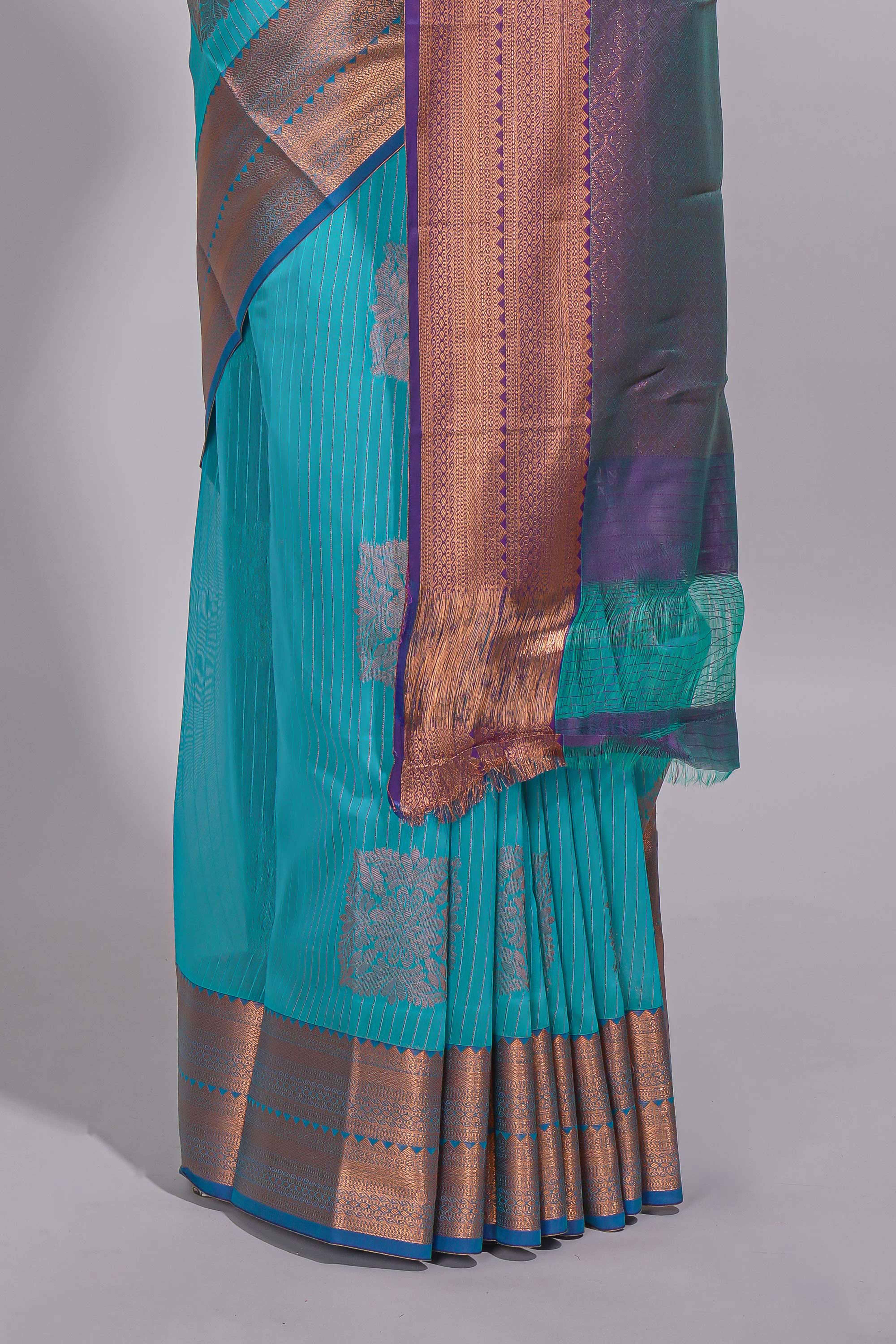 Blue tussar saree with gold zari floral buttas teal zari border and woven zari pallu with contrast blouse piece