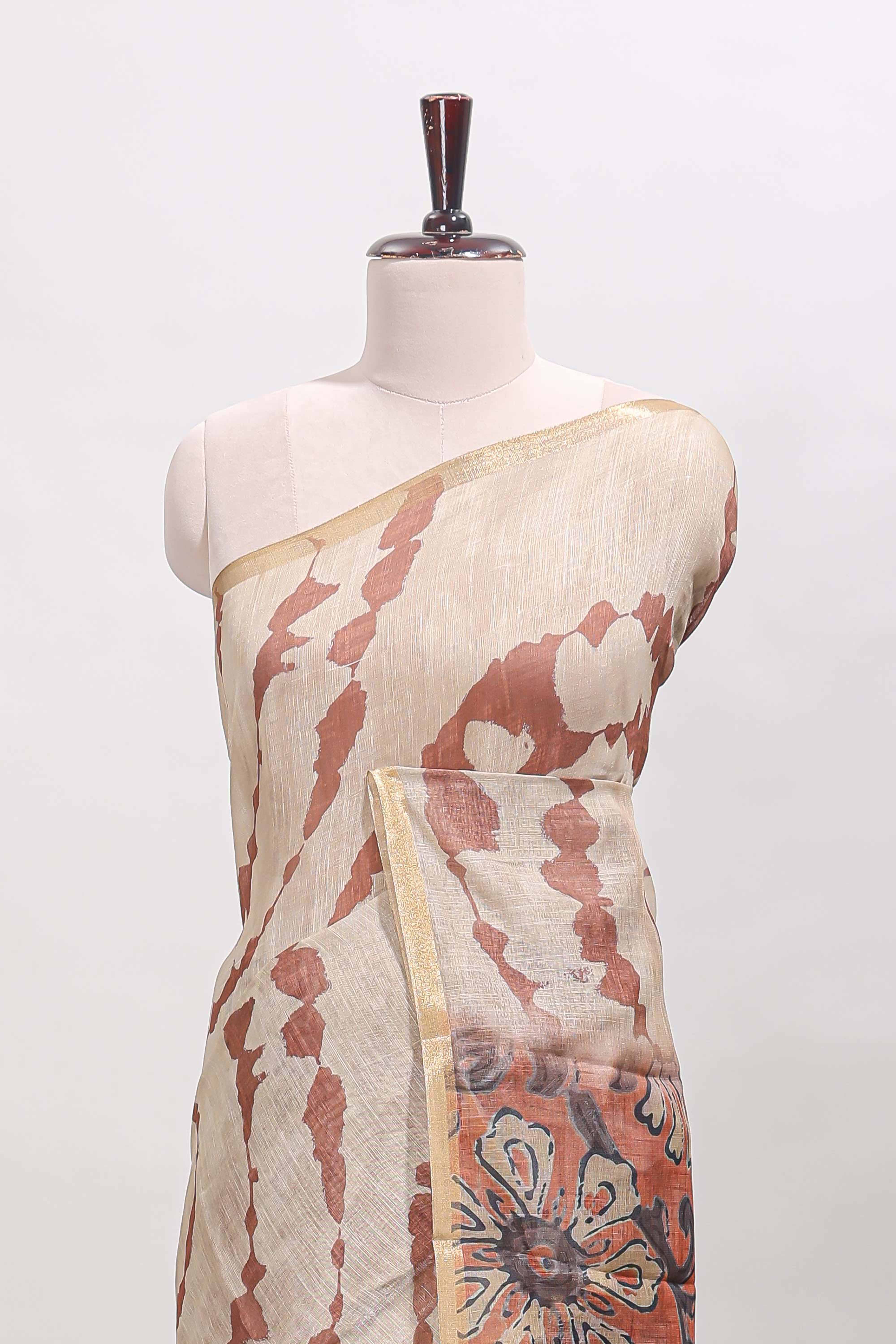 Beige linen cotton saree with brown shibori print, self zari border and floral design pallu