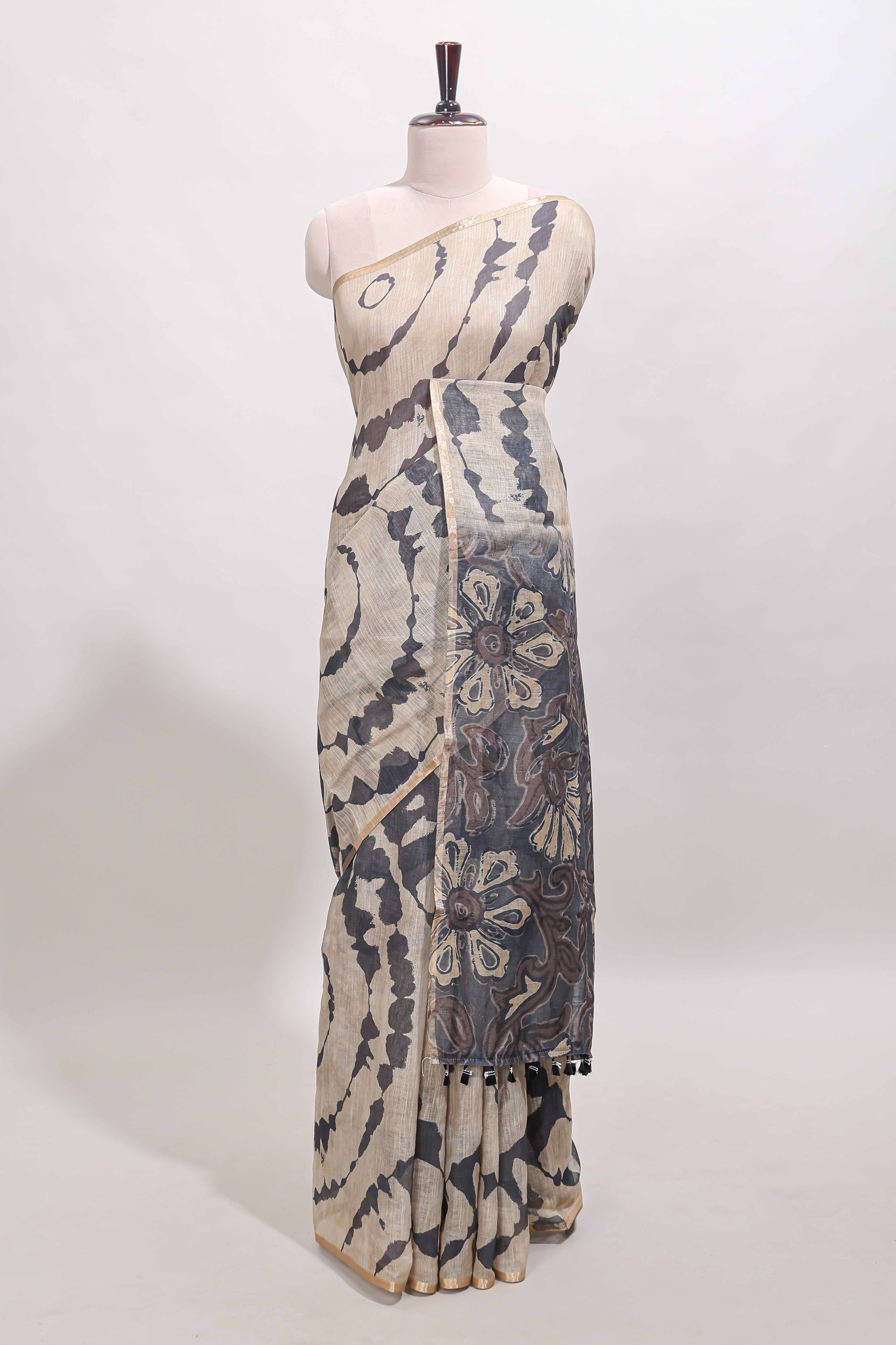 Beige linen cotton saree with grey shibori print, self zari border and floral design pallu