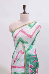 Off white chevron style shibori print linen cotton saree with contrast green border and ikkat design pallu