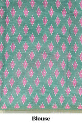Off white chevron style shibori print linen cotton saree with contrast green border and ikkat design pallu