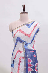 Off white chevron style shibori print linen cotton saree with contrast blue border and ikkat design pallu
