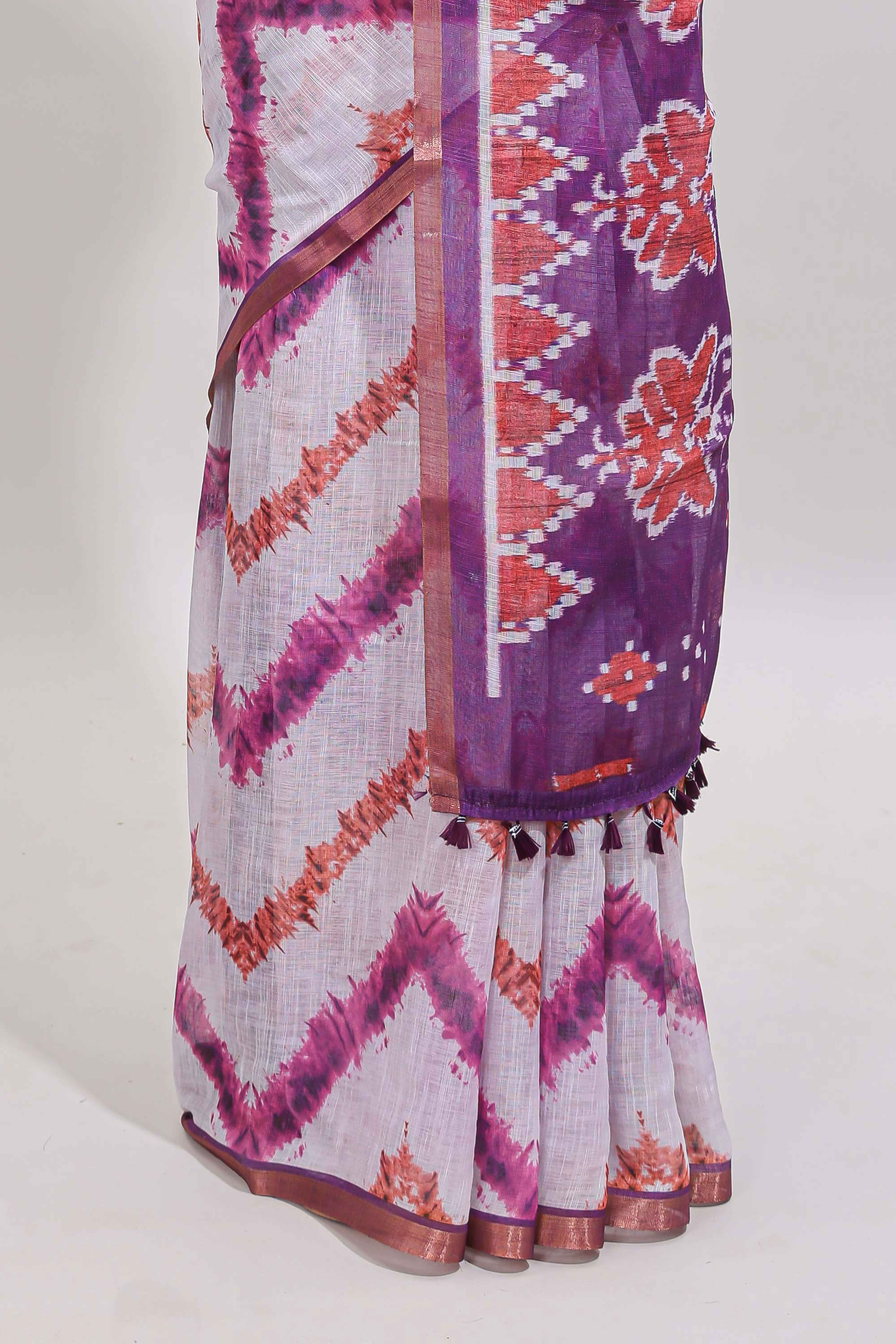 Off white chevron style shibori print linen cotton saree with contrast purple border and ikkat design pallu