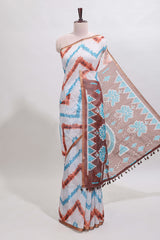 Off white chevron style shibori print linen cotton saree with contrast brown border and ikkat design pallu