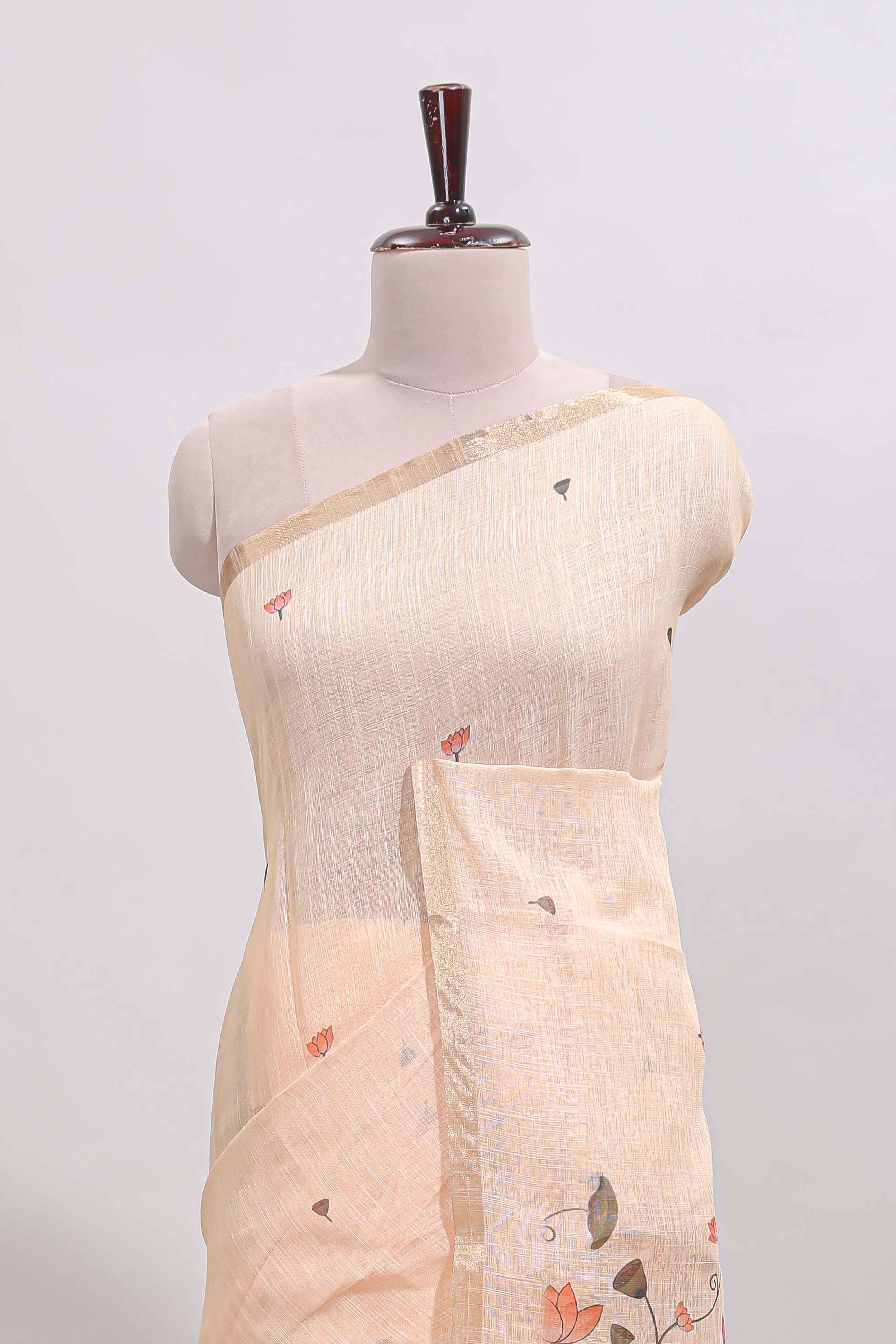 Cream floral design linen cotton saree with self zari border, matching pallu and contrast blouse