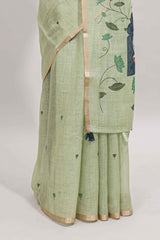 Green floral design linen cotton saree with self zari border, matching pallu and contrast blouse
