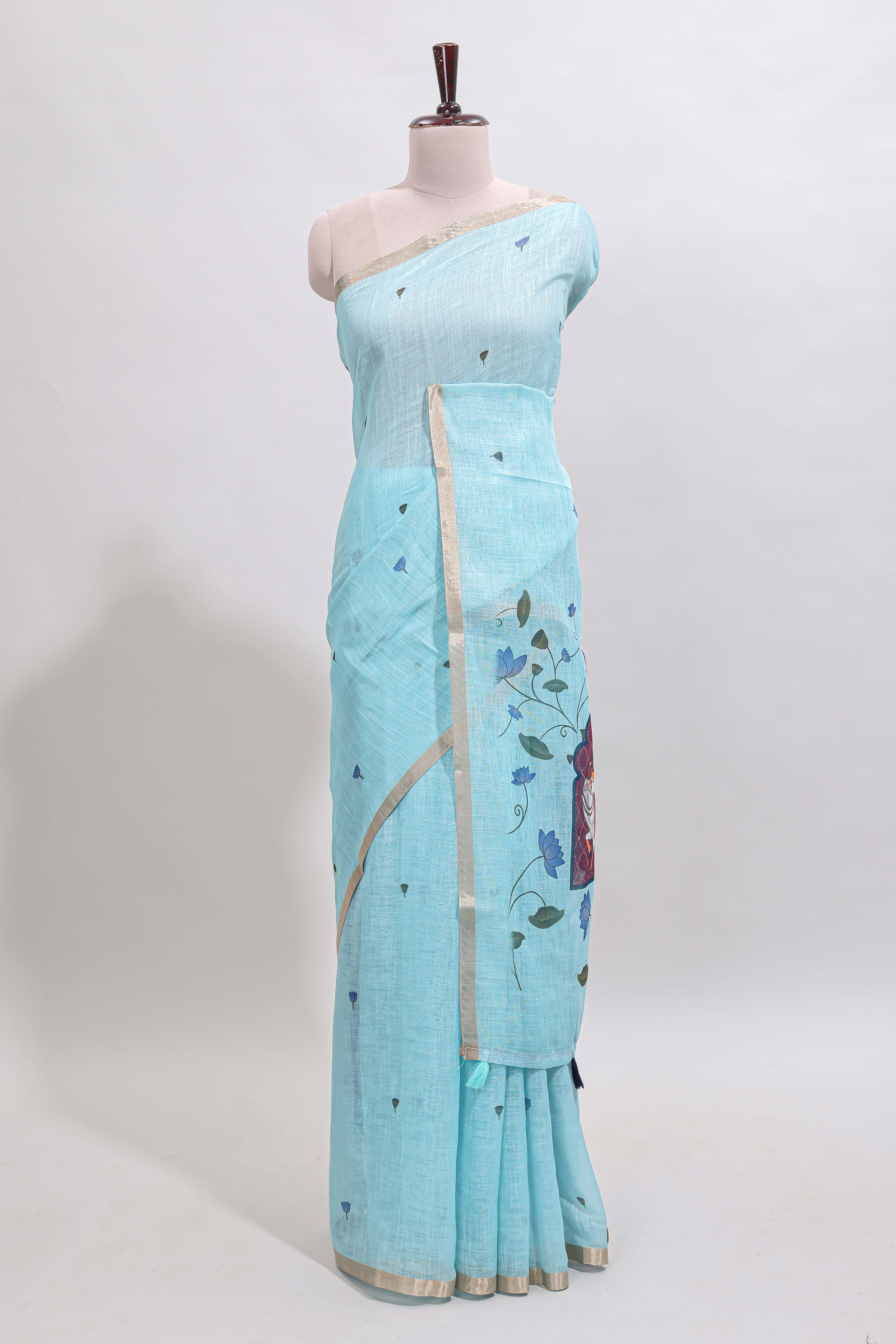Blue floral design linen cotton saree with self zari border, matching pallu and contrast blouse