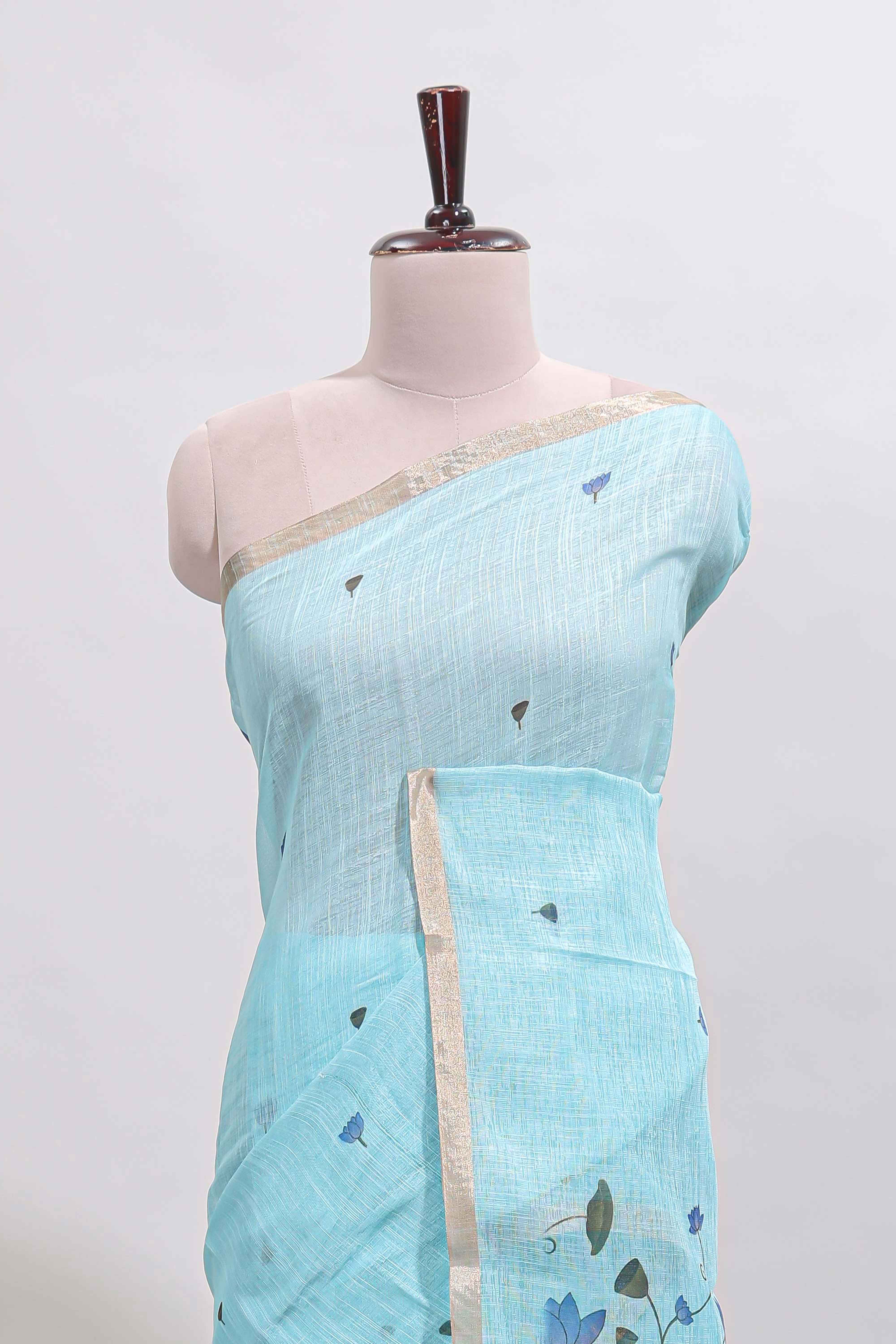 Blue floral design linen cotton saree with self zari border, matching pallu and contrast blouse