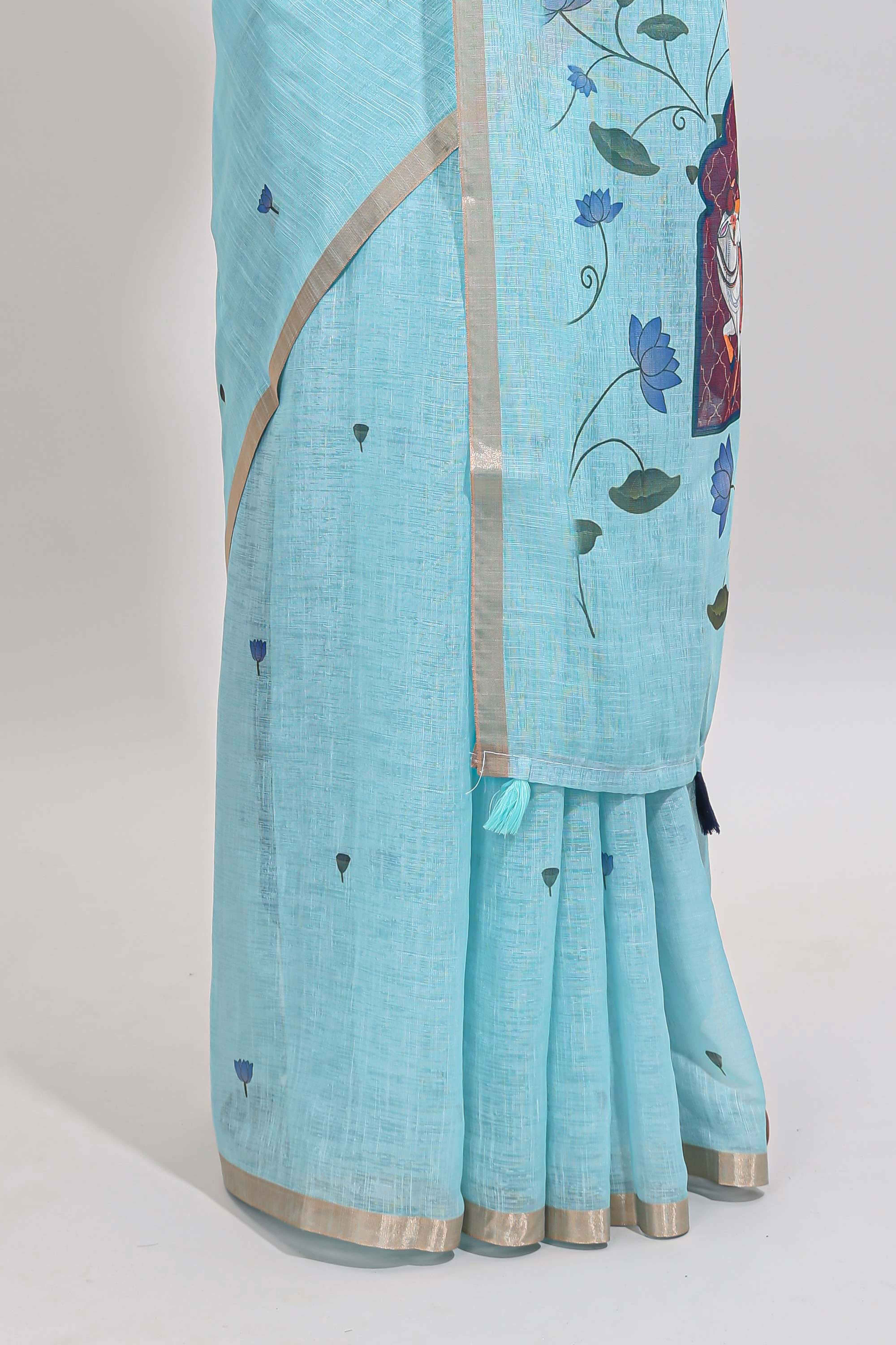 Blue floral design linen cotton saree with self zari border, matching pallu and contrast blouse