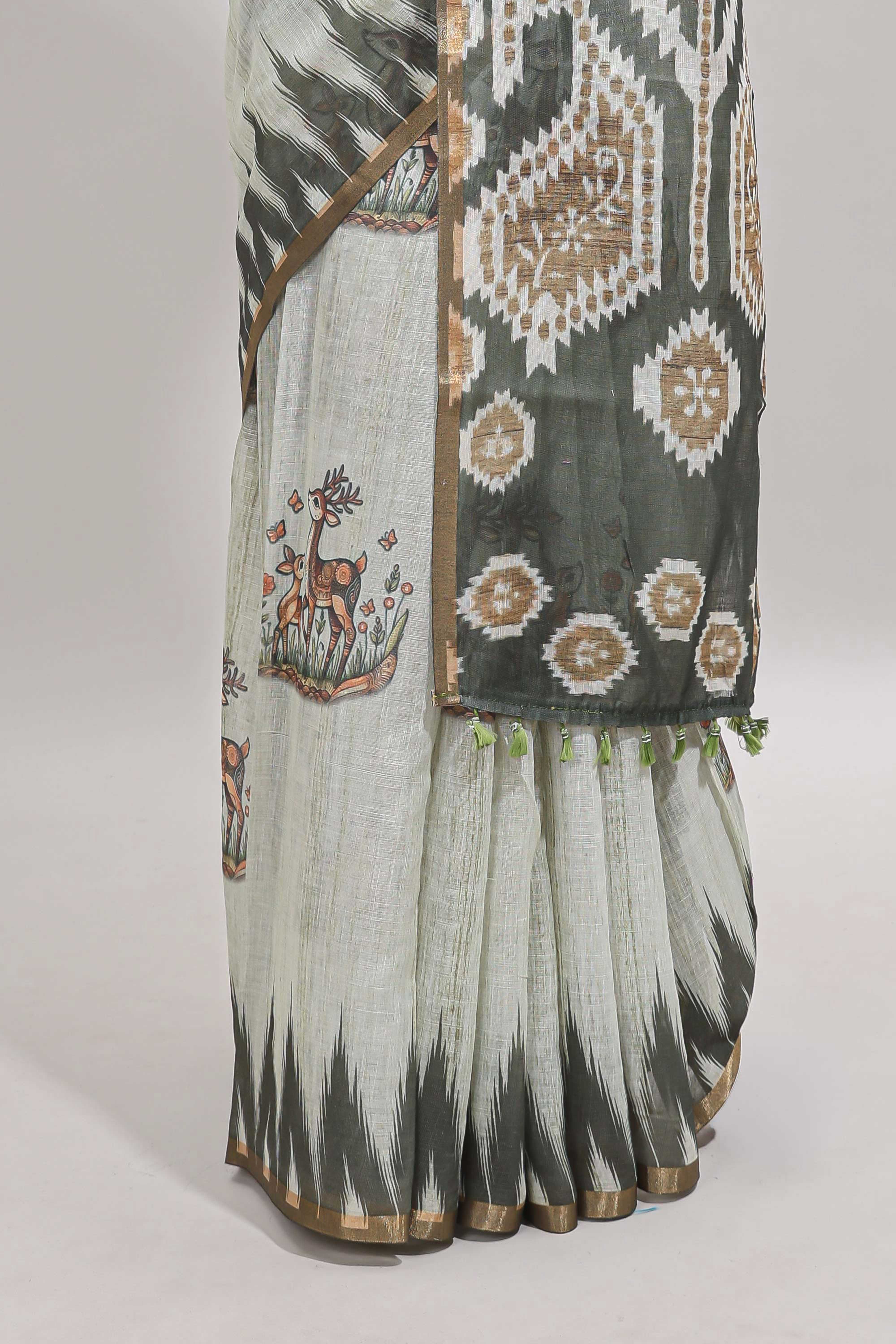 Green deer & fawn motifs linen cotton saree with self zari border and contrast ikkat style pallu