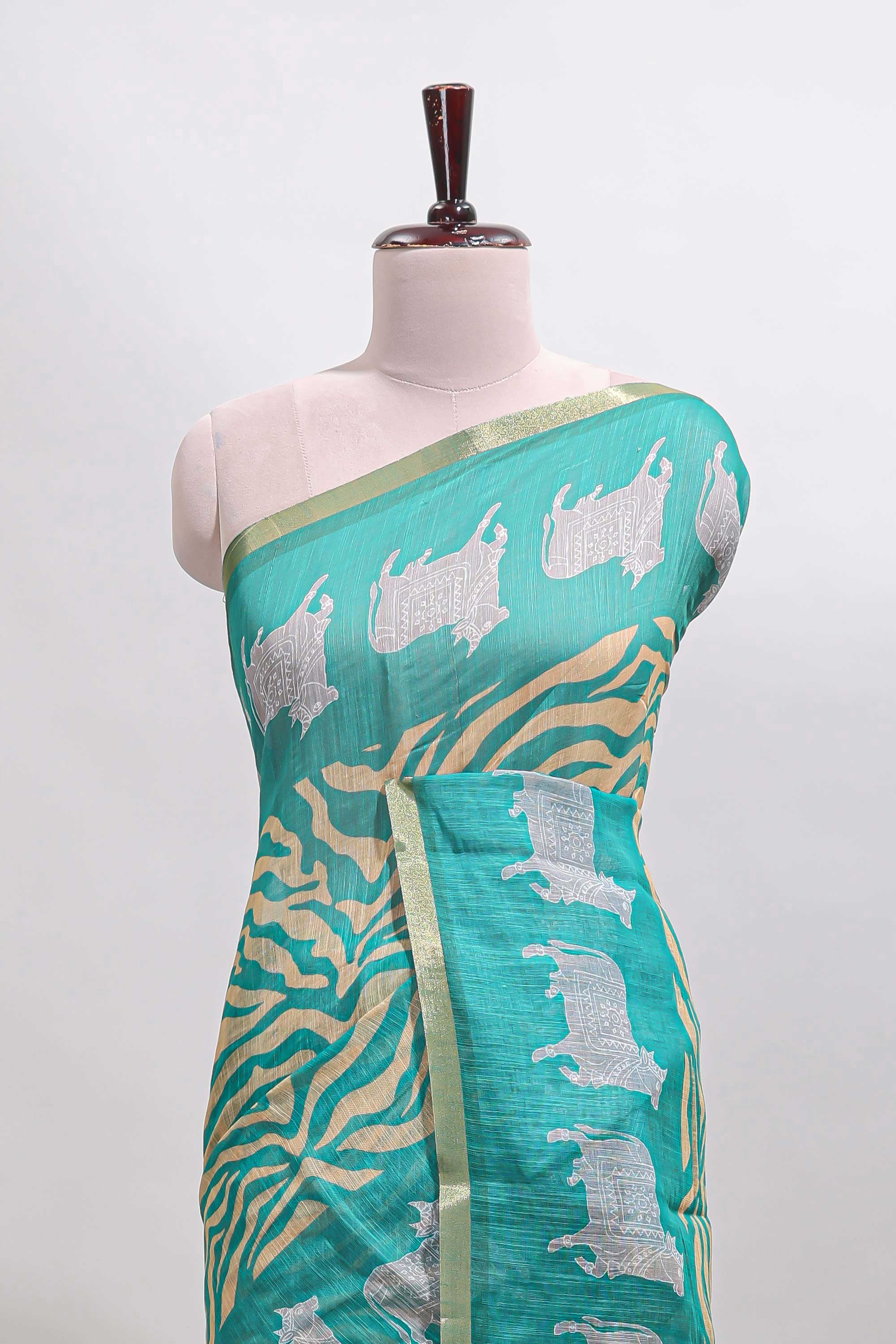 Turquoise green pichwai cow prints & Zebra inspired pattern linen cotton saree with self zari border and matching blouse