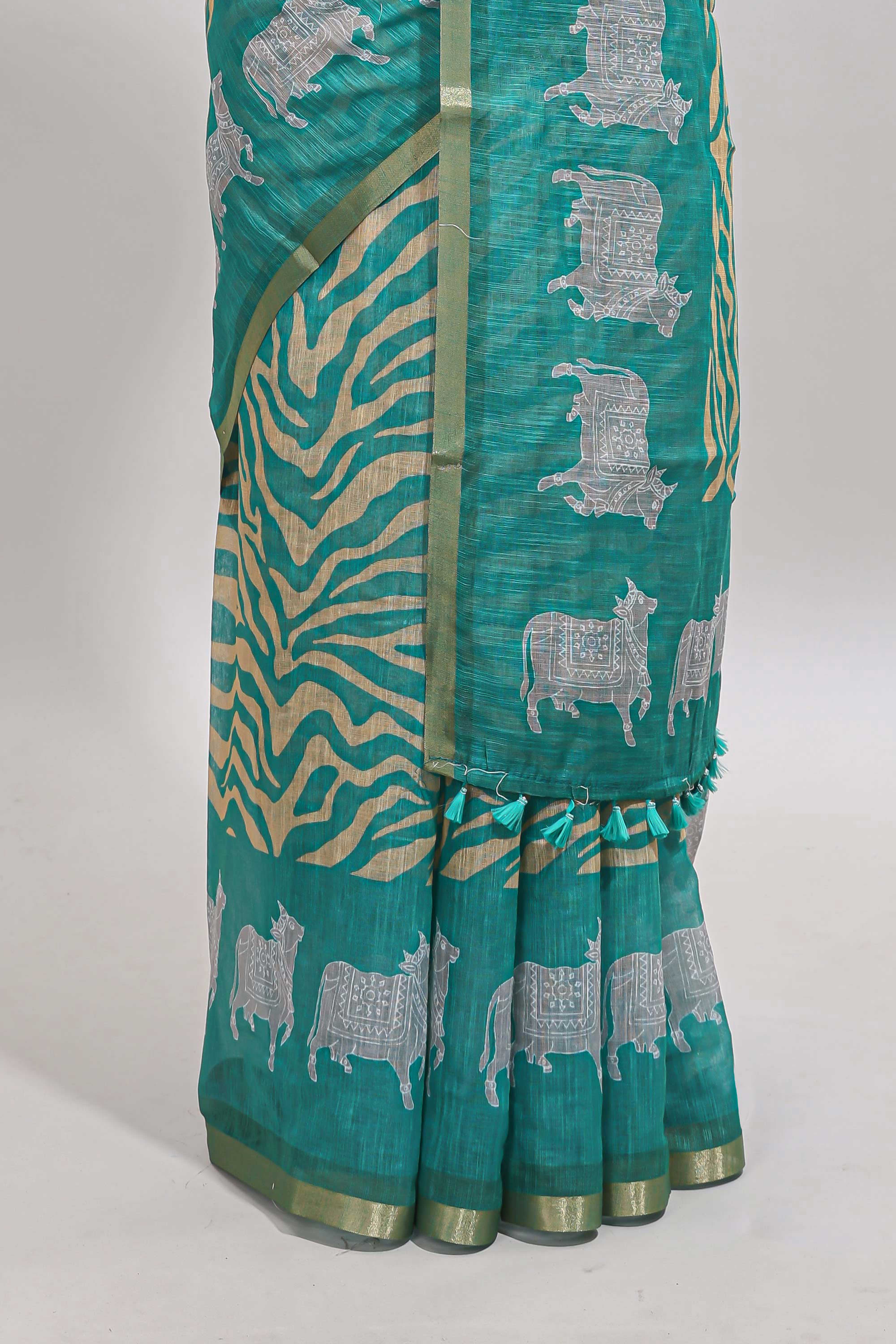 Turquoise green pichwai cow prints & Zebra inspired pattern linen cotton saree with self zari border and matching blouse
