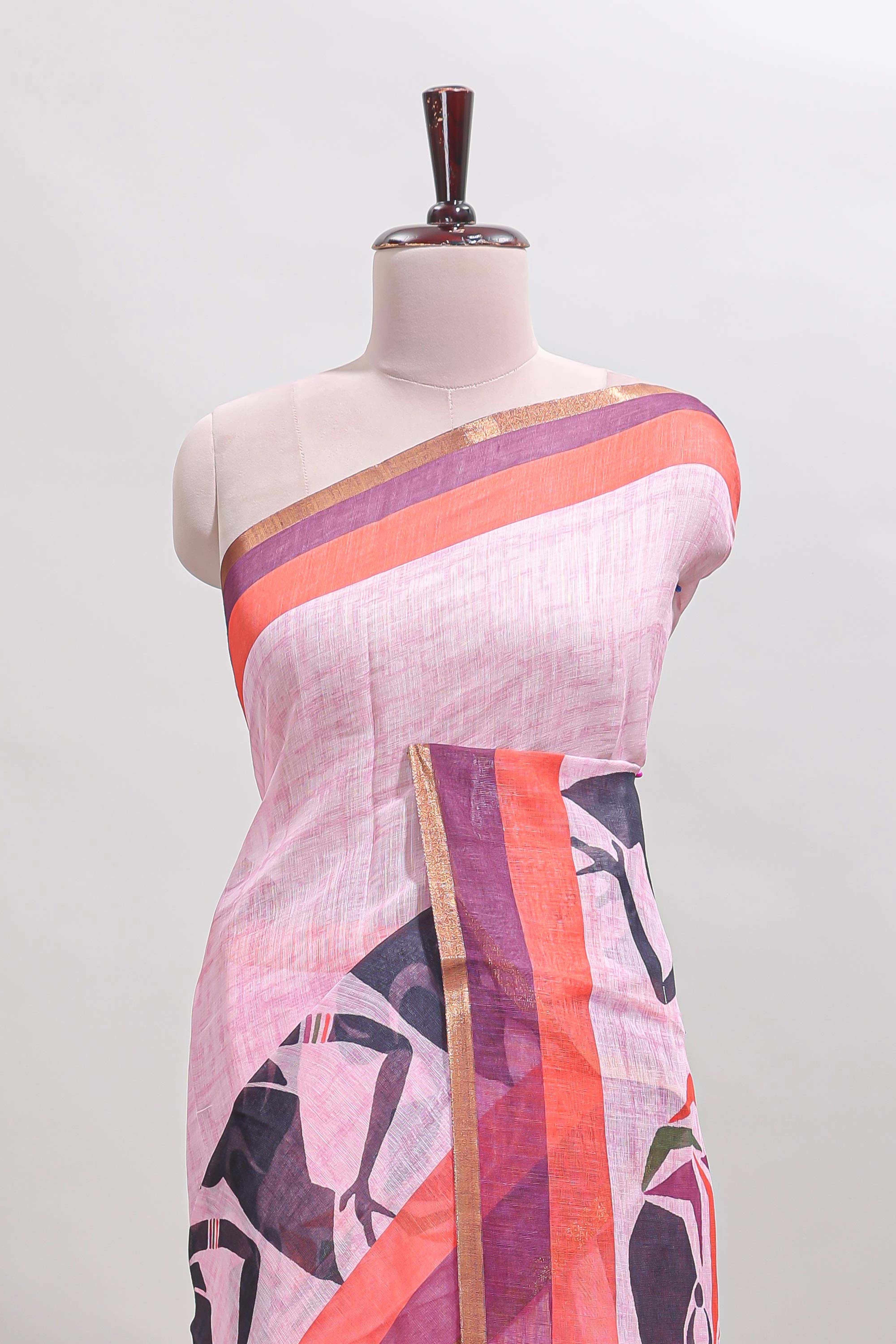 Light pink artistic traditional tribal print linen cotton saree with contrast border and striped blouse