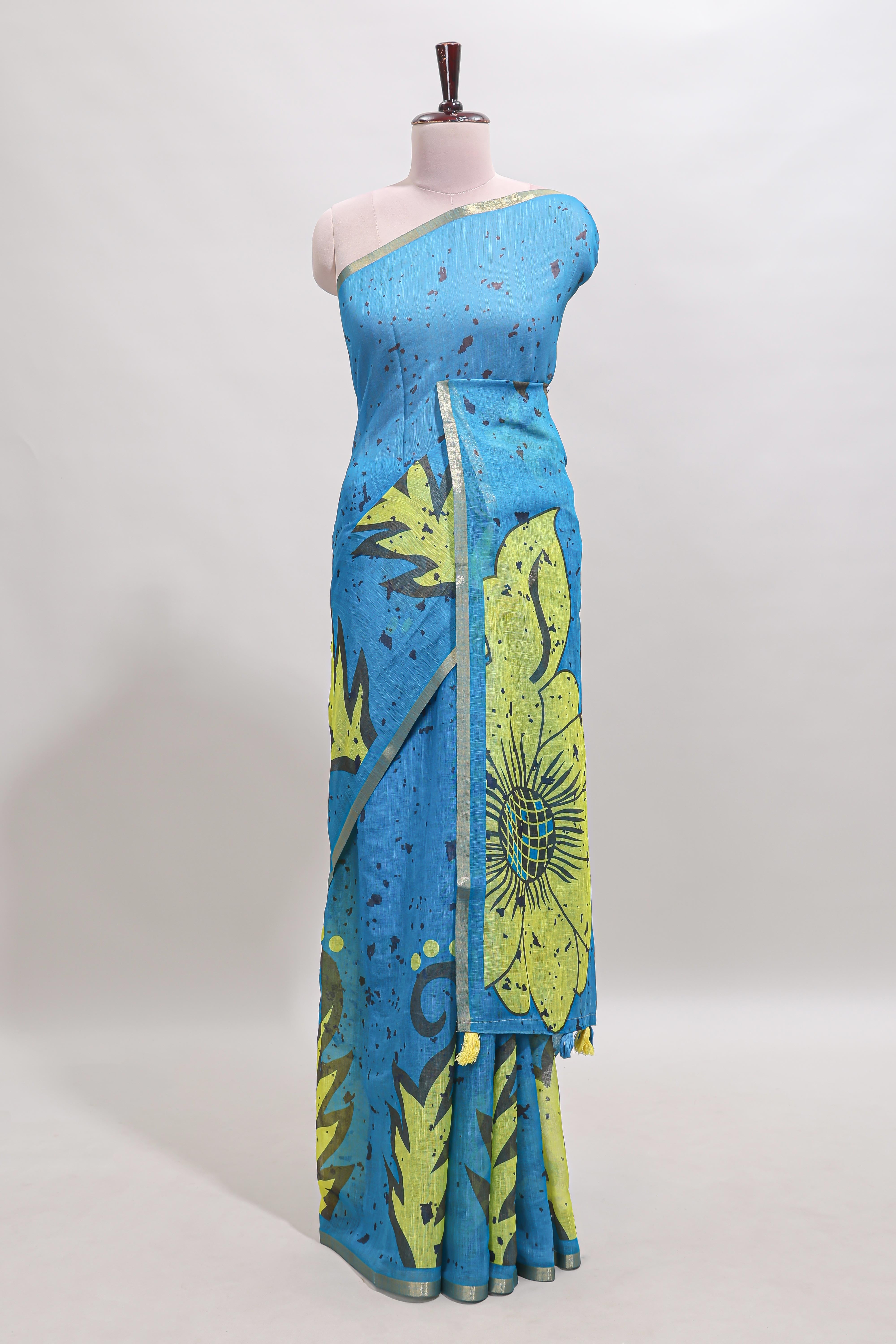 Blue floral design linen cotton saree with self zari border and contrast blouse