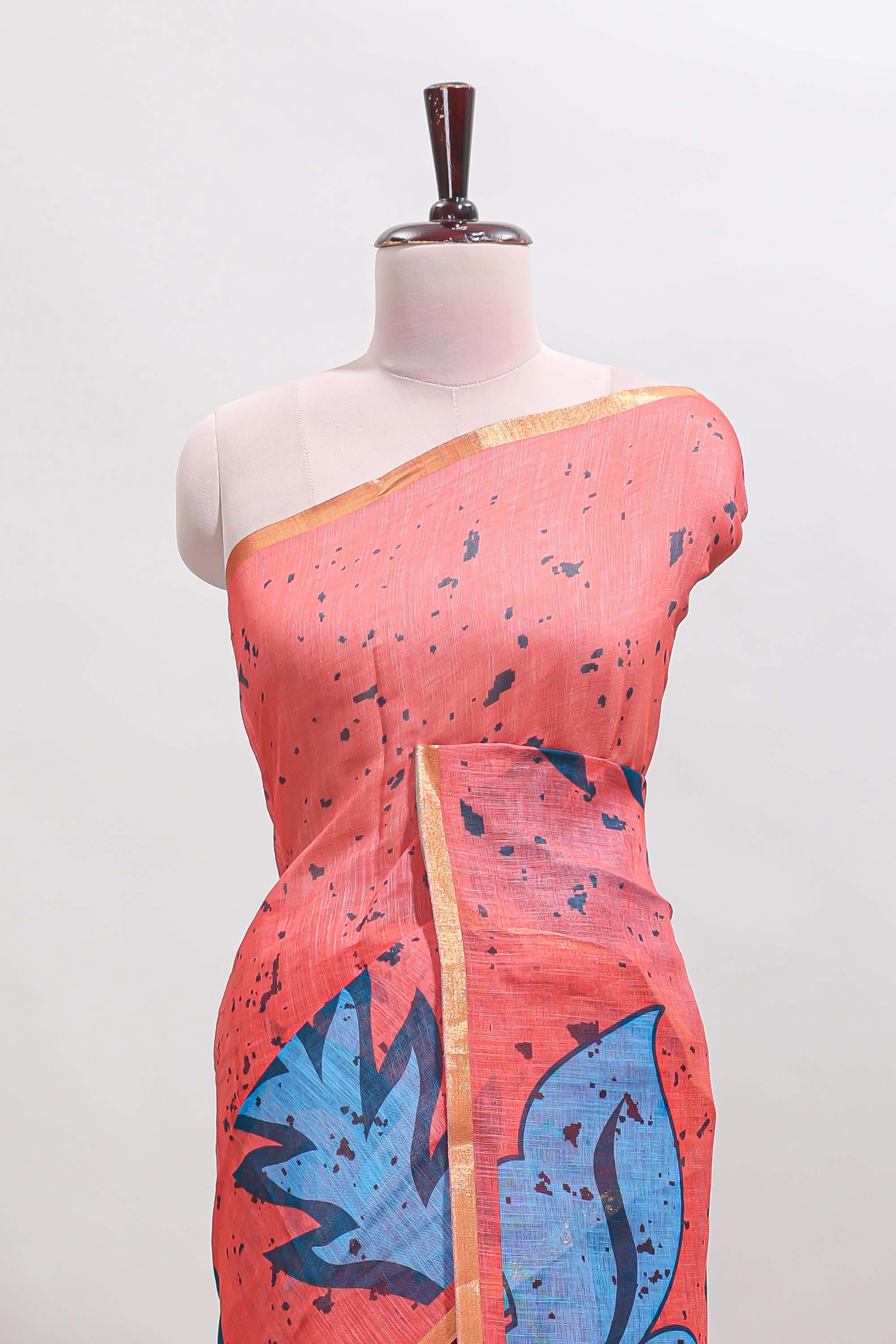 Orange floral design linen cotton saree with self zari border and contrast blouse