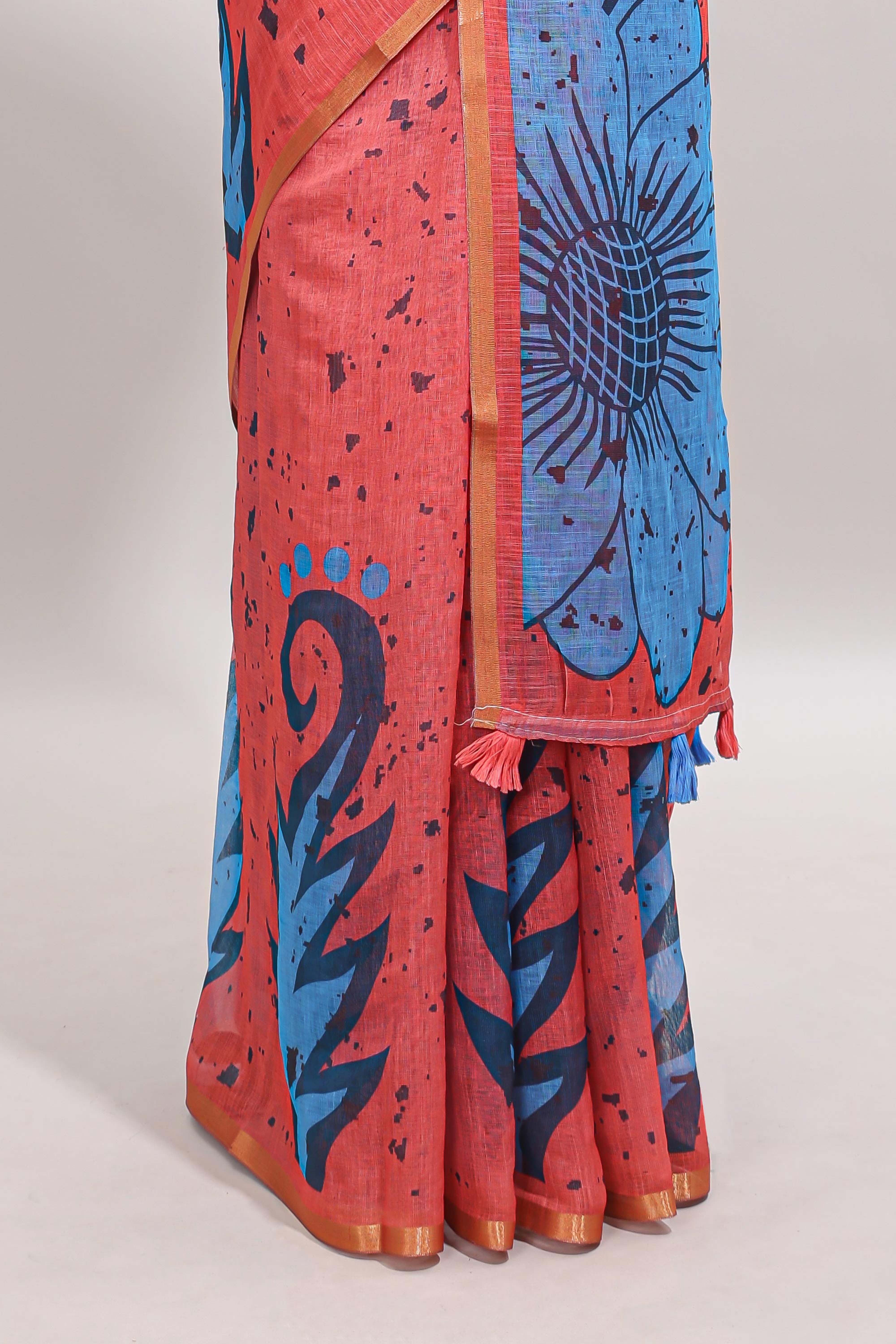 Orange floral design linen cotton saree with self zari border and contrast blouse