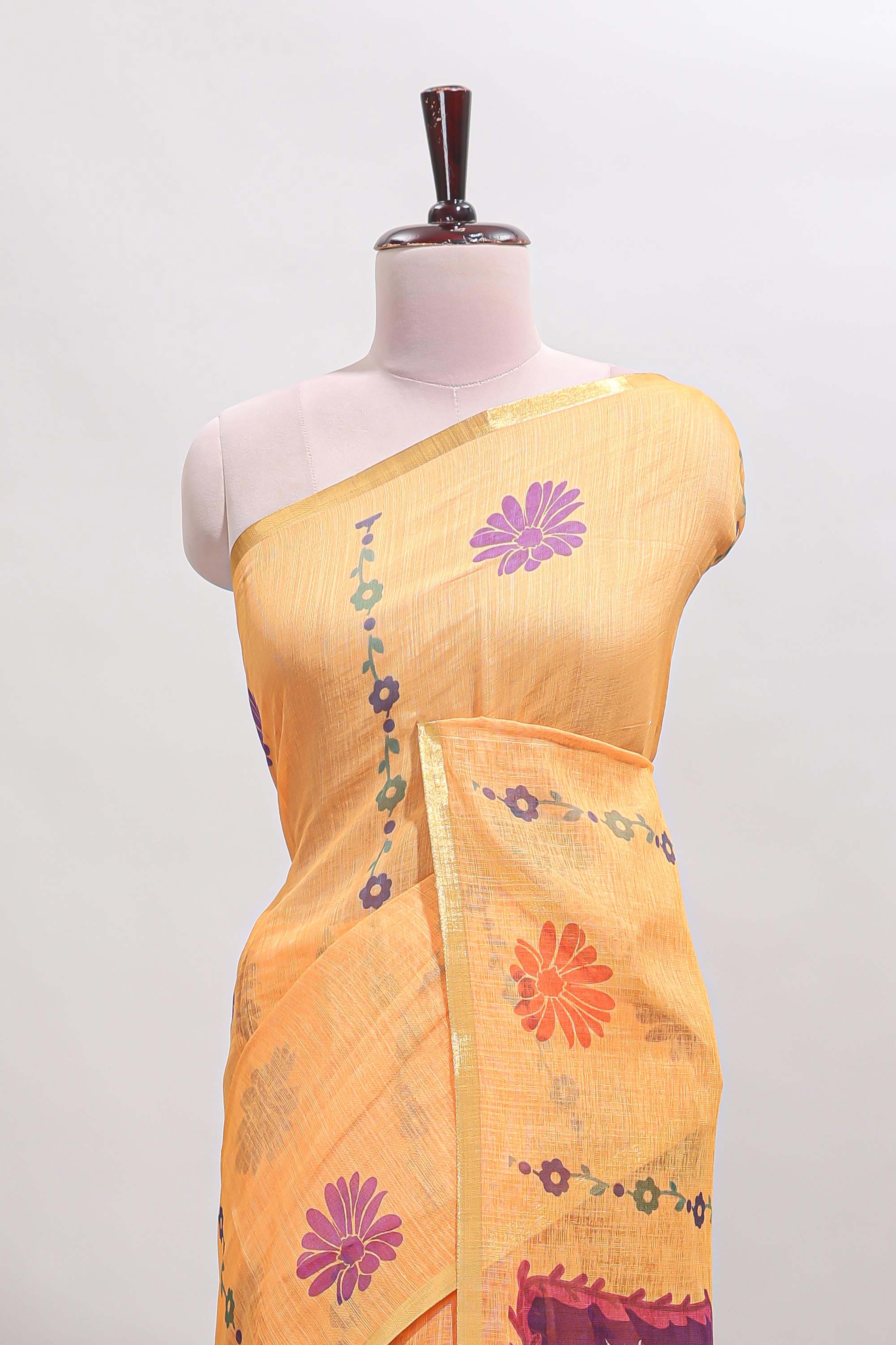 Orange floral design linen cotton saree with self zari border and contrast blouse