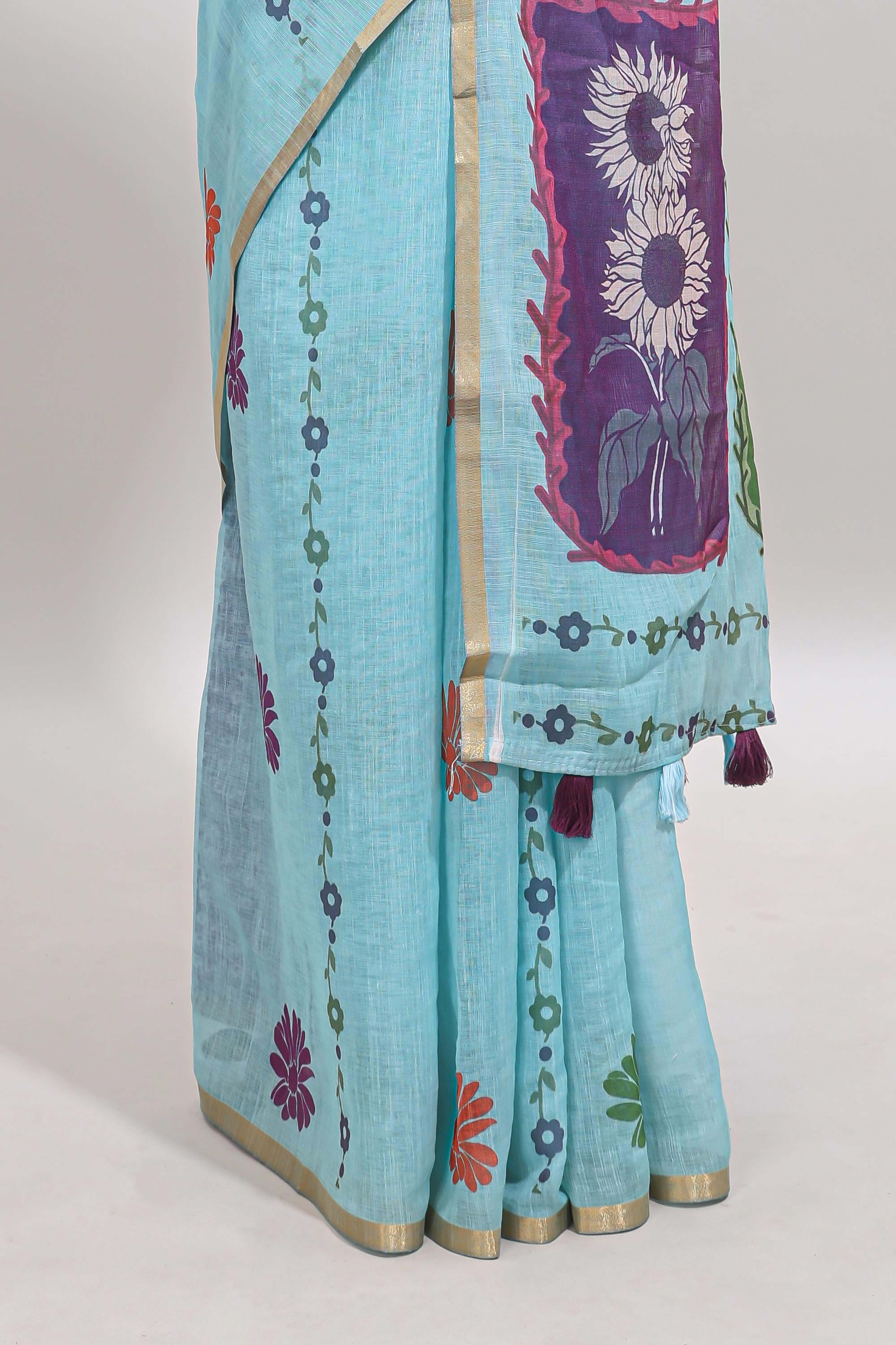 Blue floral design linen cotton saree with self zari border and contrast blouse
