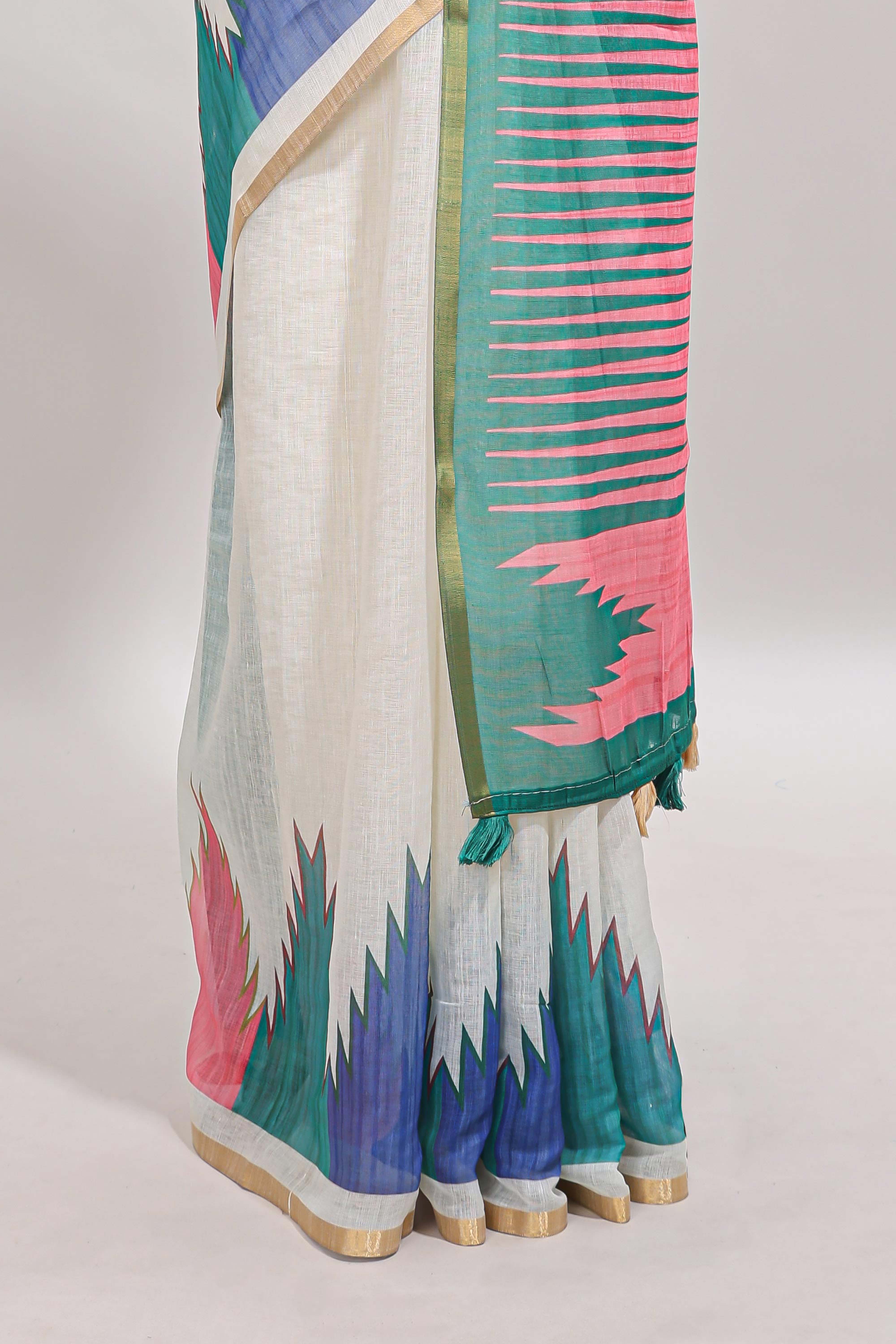 Cream ikkat style linen cotton saree with self zari border and contrast blouse
