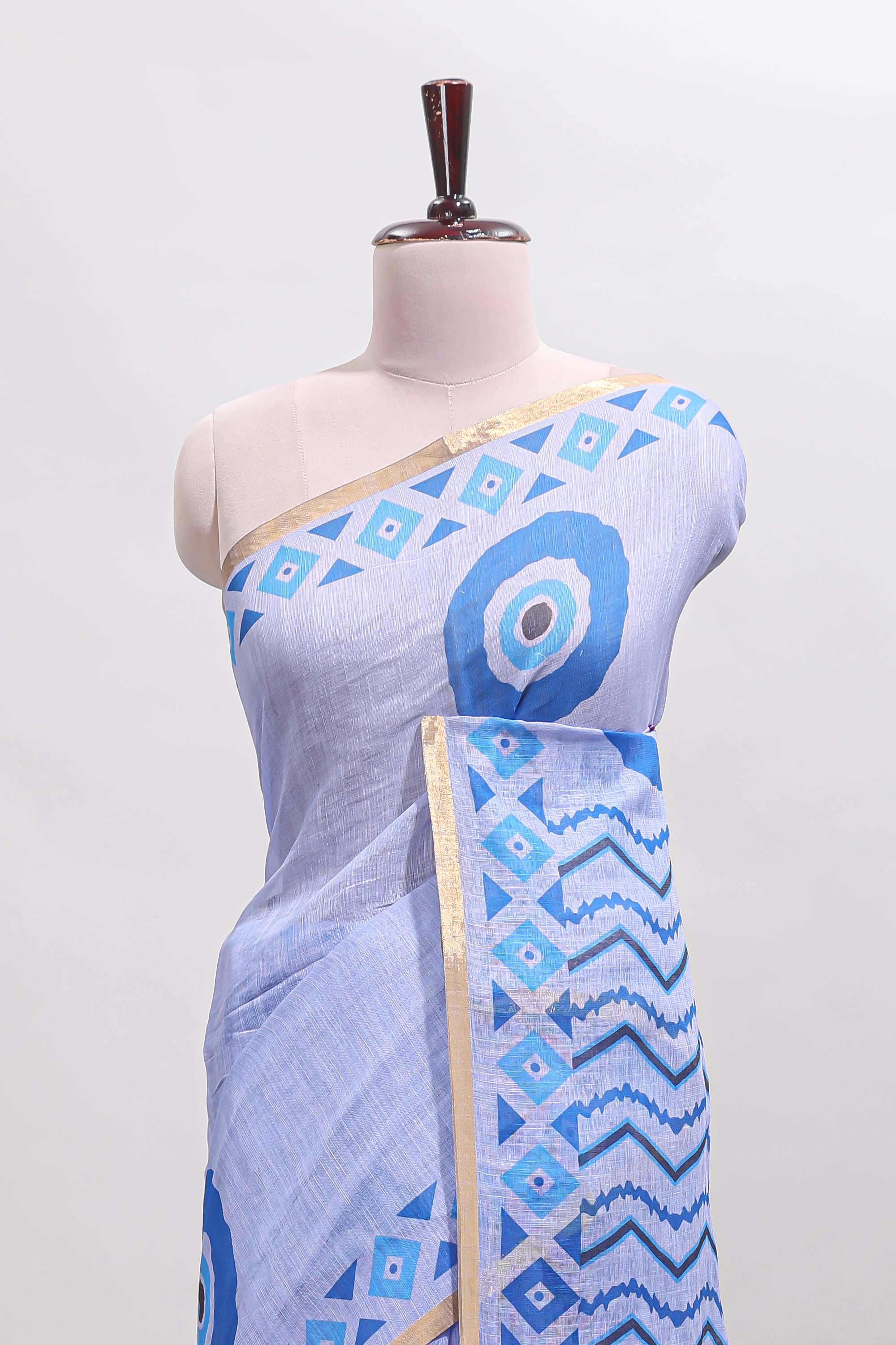 Blue nazar print design linen cotton saree with self zari border and contrast blouse