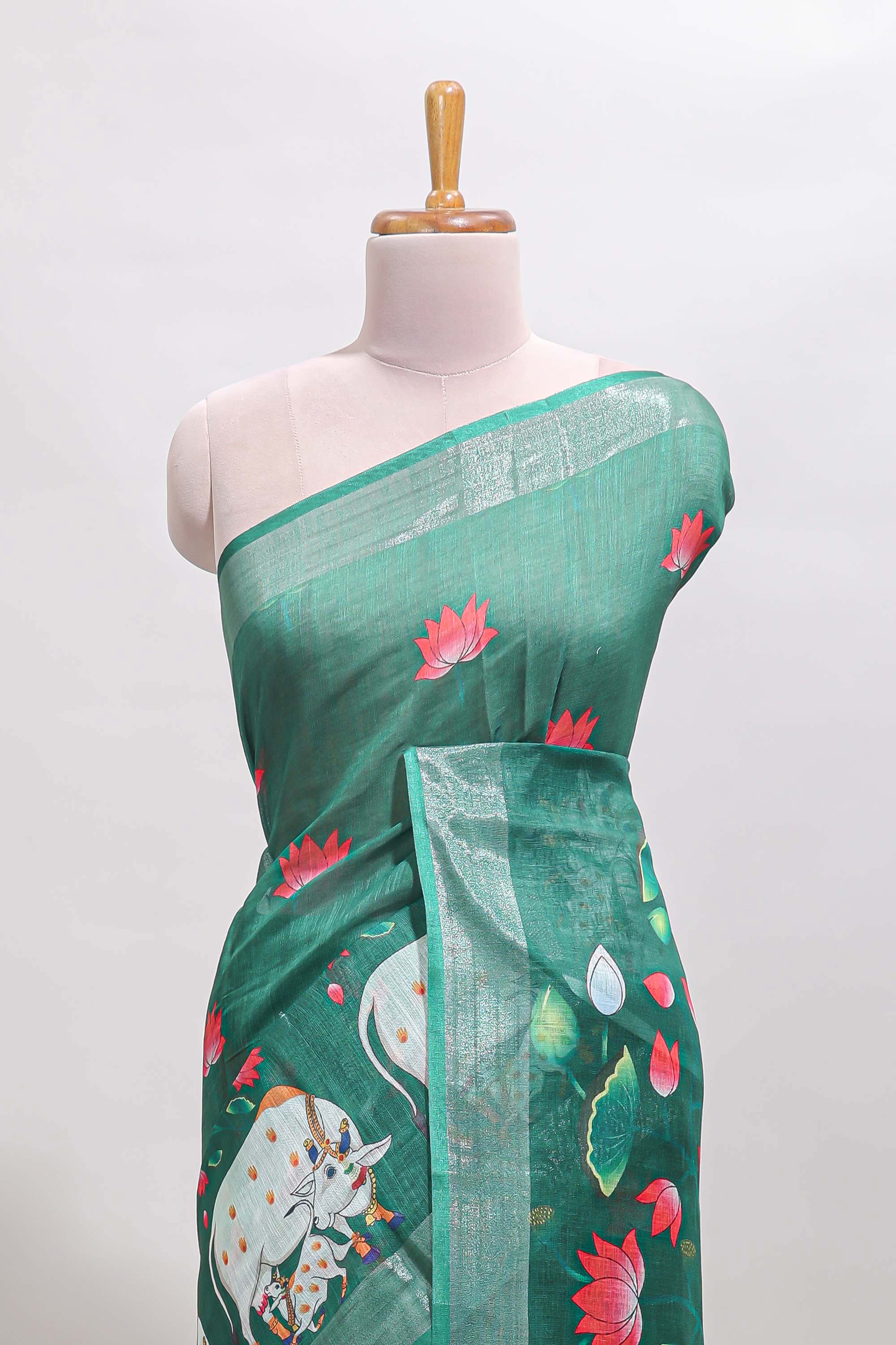 Green floral & cow design linen cotton saree with self silver zari border and matching blouse