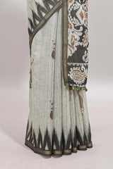 Green tribal dance dance motifs linen cotton saree with contrast ikkat border and printed pallu