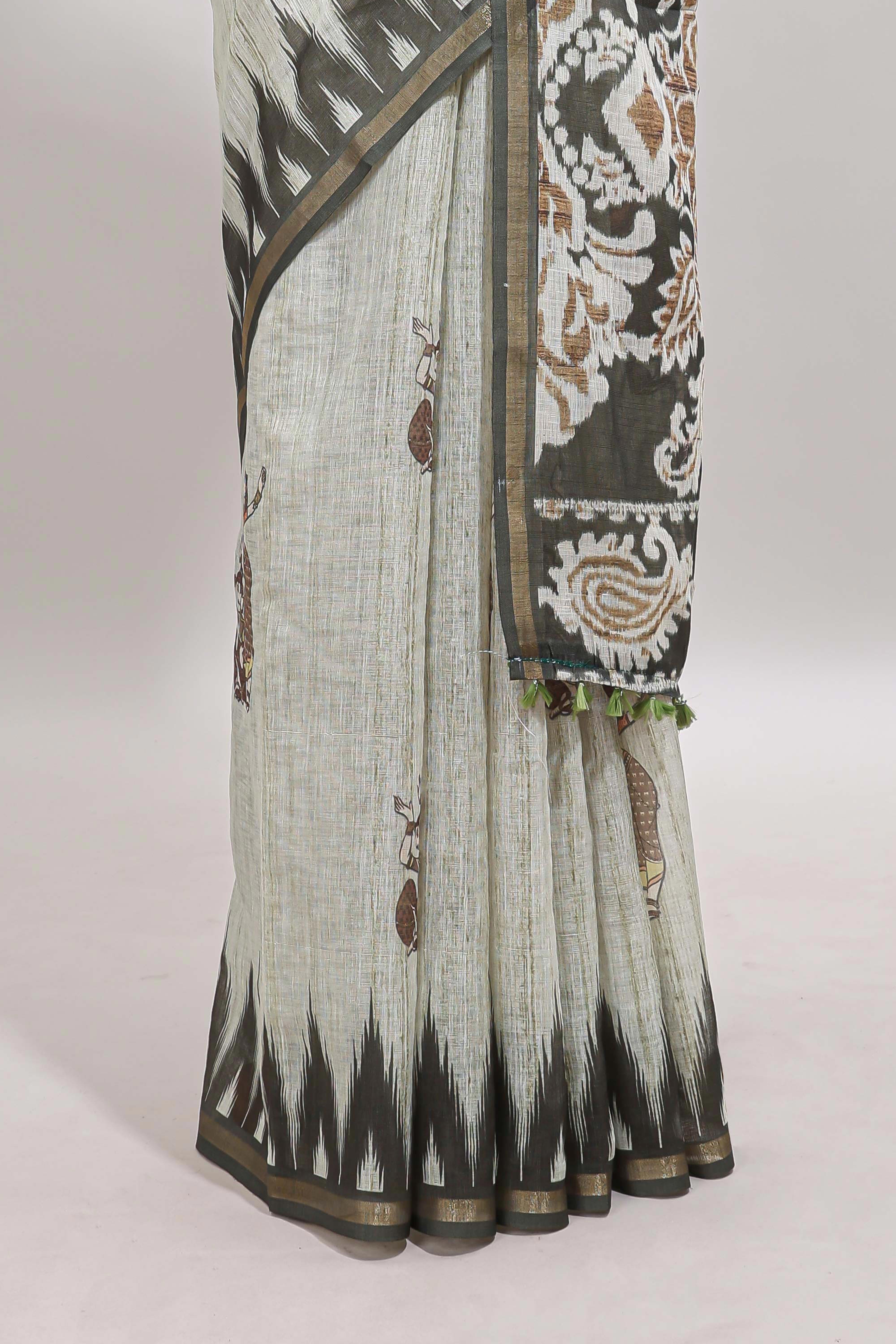 Green tribal dance dance motifs linen cotton saree with contrast ikkat border and printed pallu