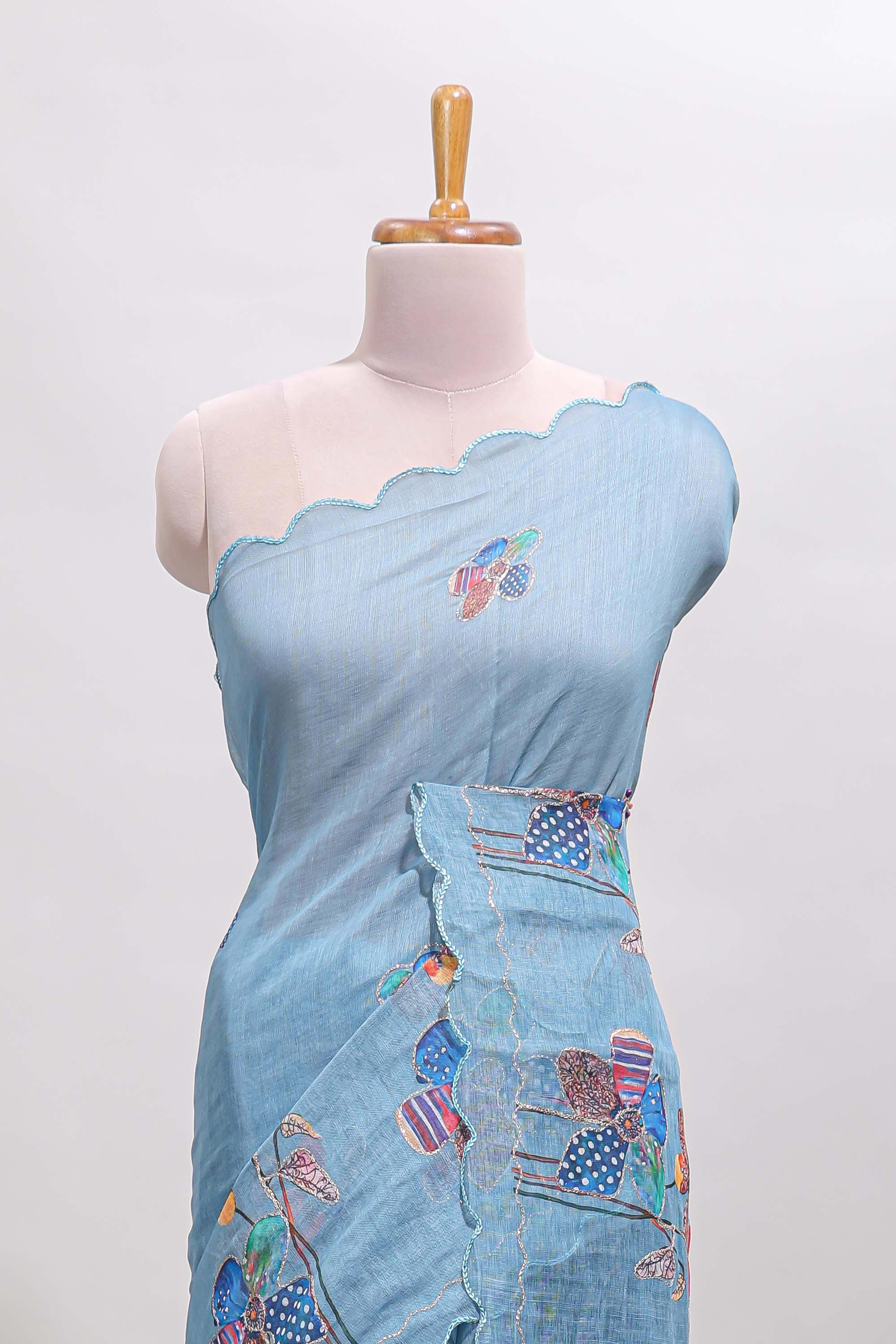 Blue floral design linen cotton saree with scallop border and matching printed blouse