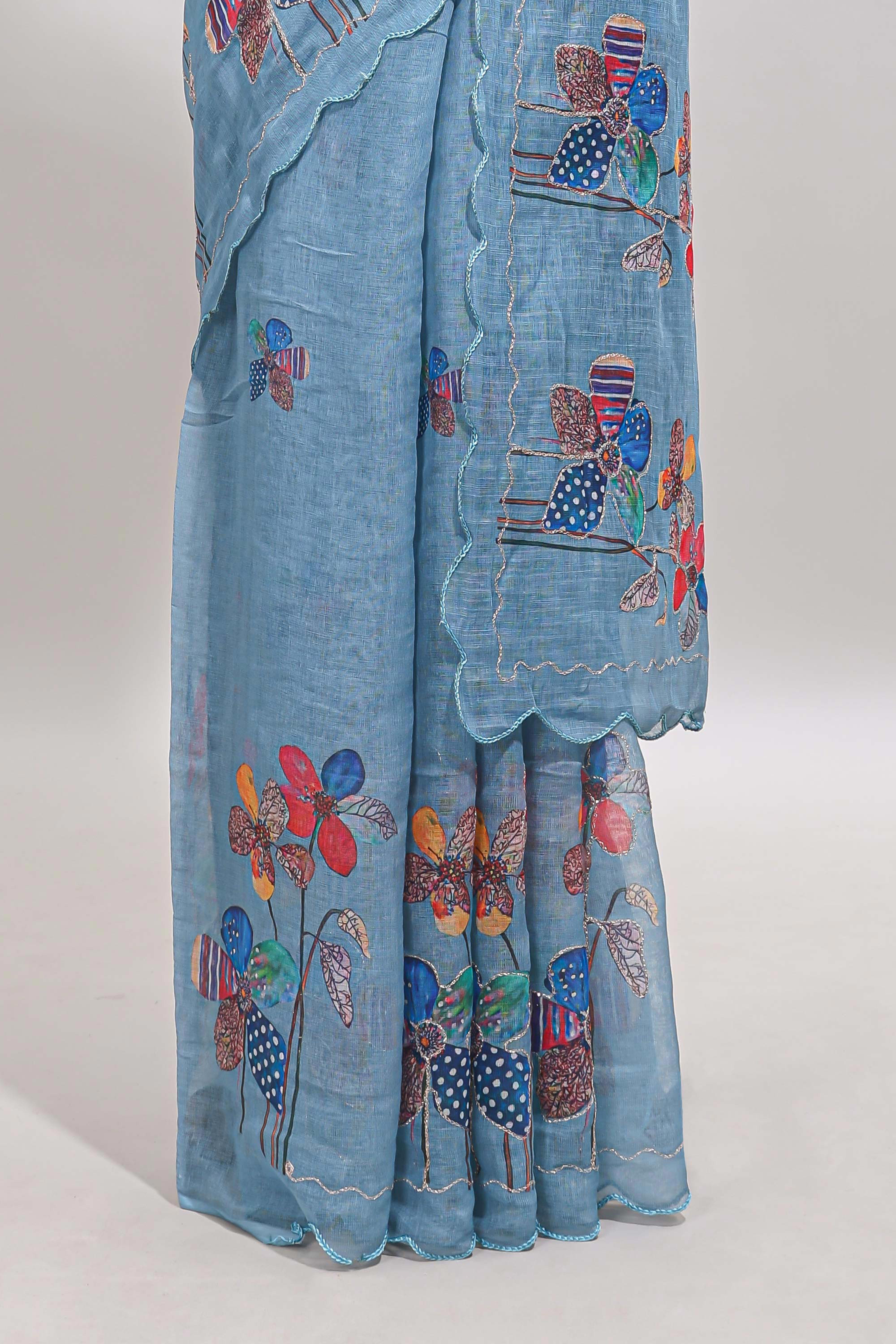 Blue floral design linen cotton saree with scallop border and matching printed blouse