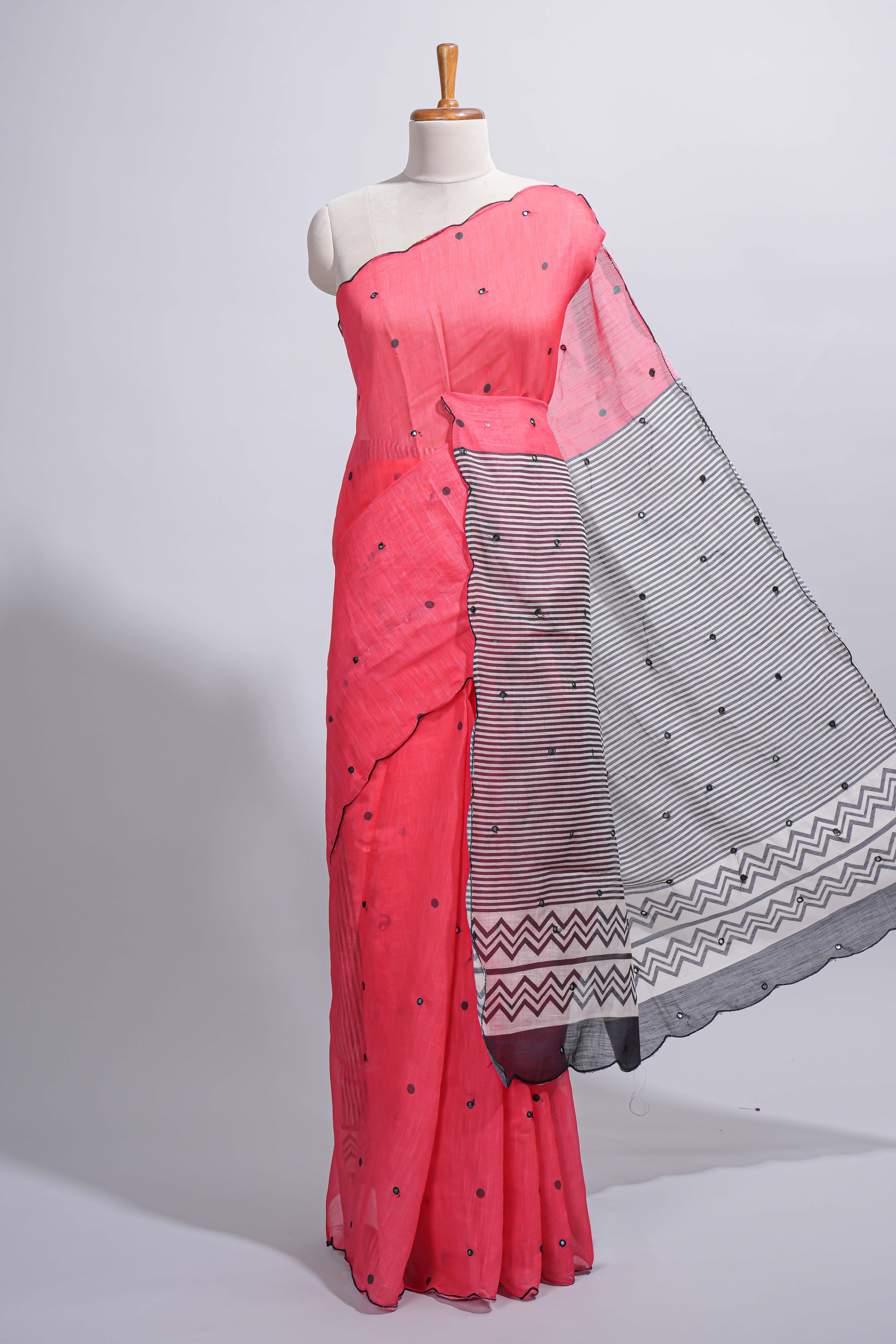 Coral pink linen cotton saree withsequin details striped and geometric zigzag pallu with scallop border along with striped blouse