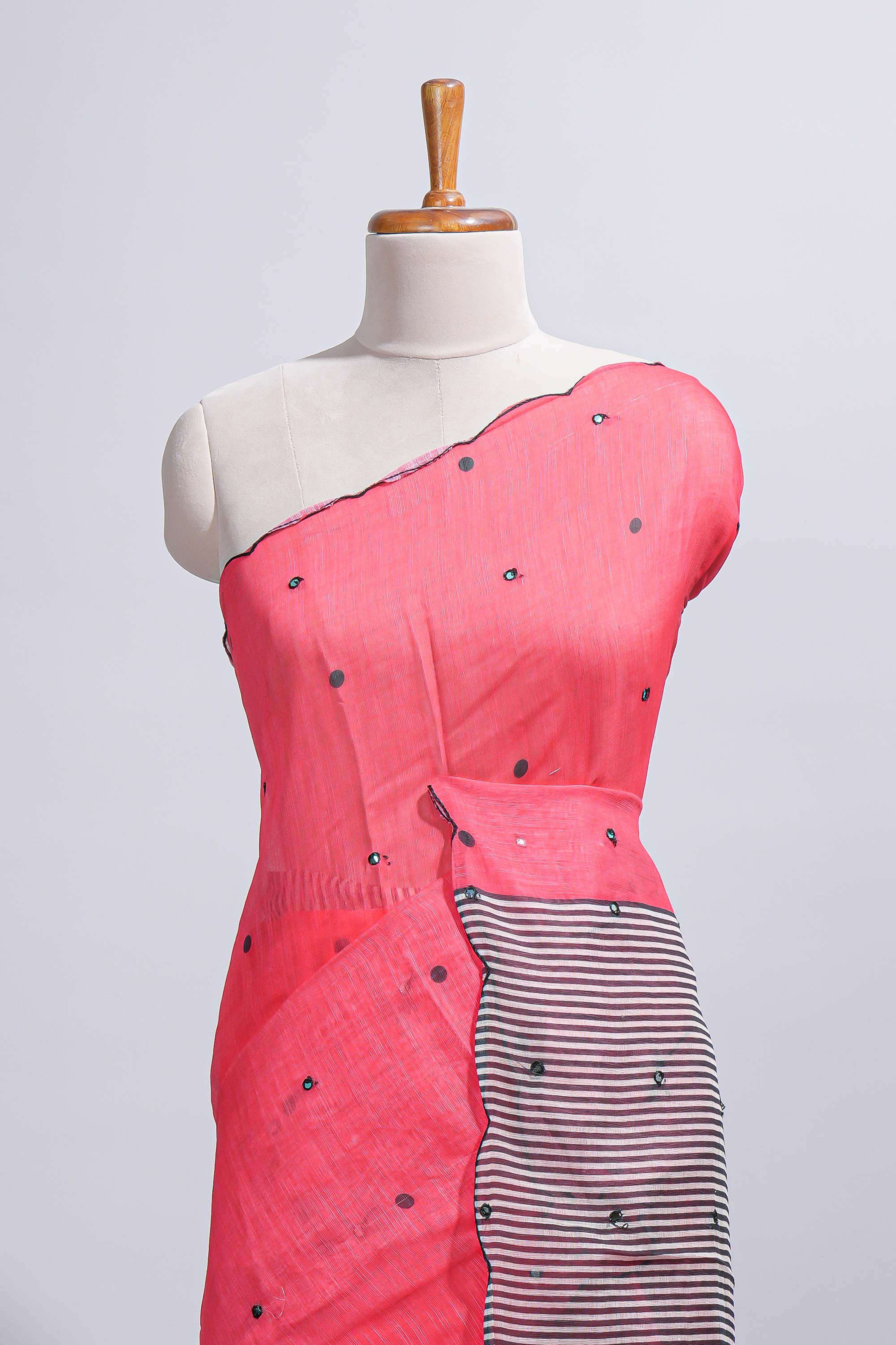 Coral pink linen cotton saree withsequin details striped and geometric zigzag pallu with scallop border along with striped blouse
