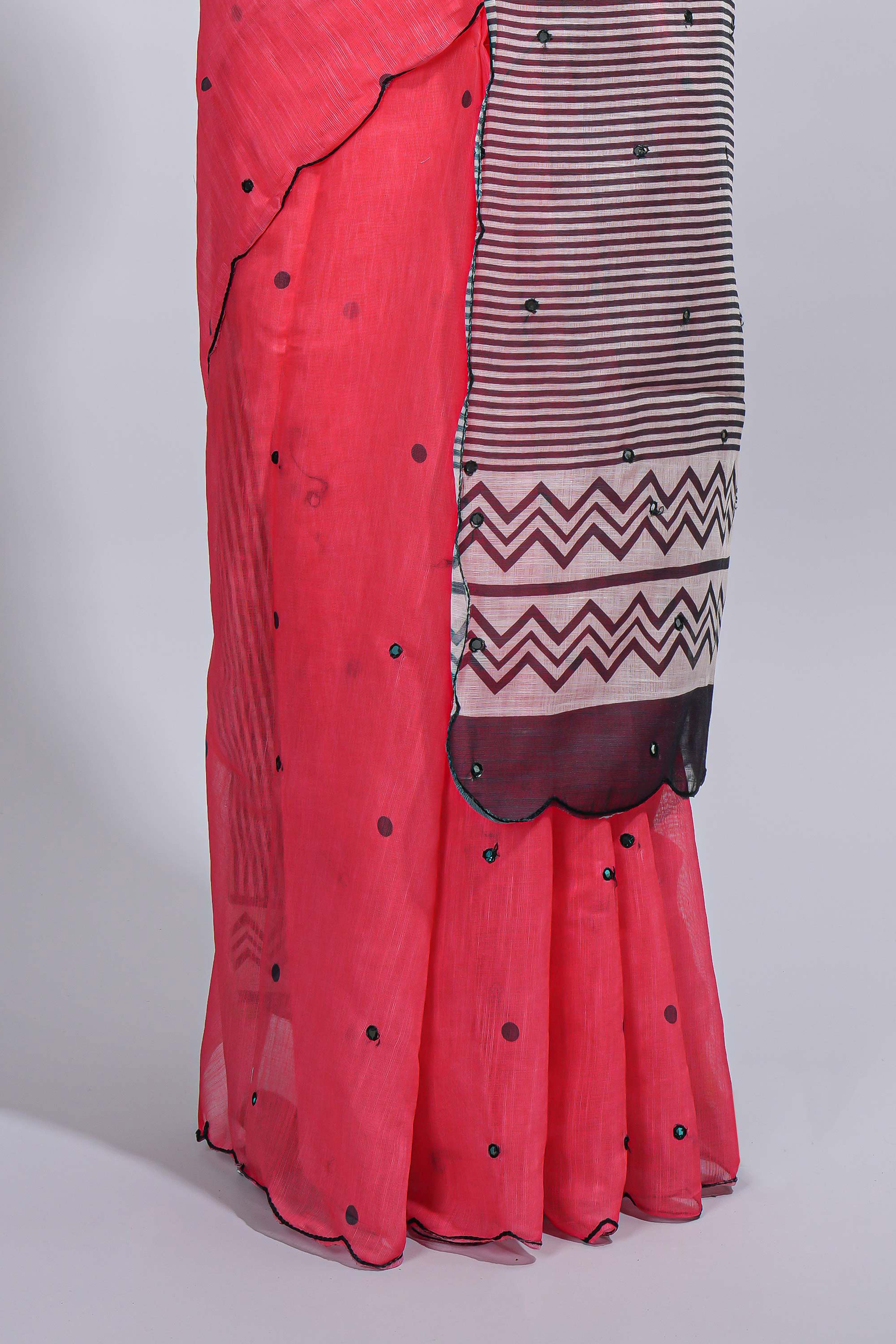 Coral pink linen cotton saree withsequin details striped and geometric zigzag pallu with scallop border along with striped blouse