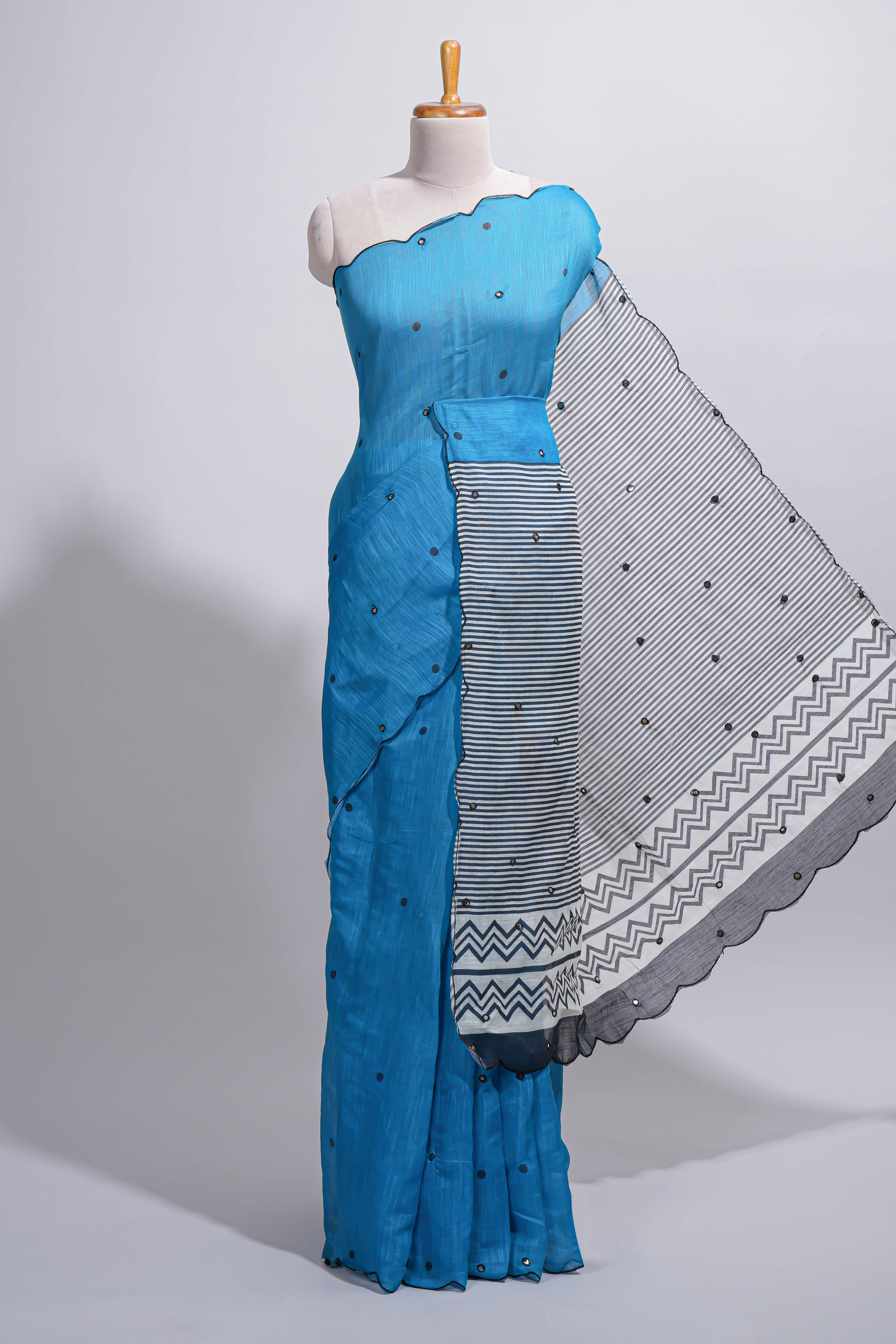 Blue linen cotton saree withsequin details striped and geometric zigzag pallu with scallop border along with striped blouse