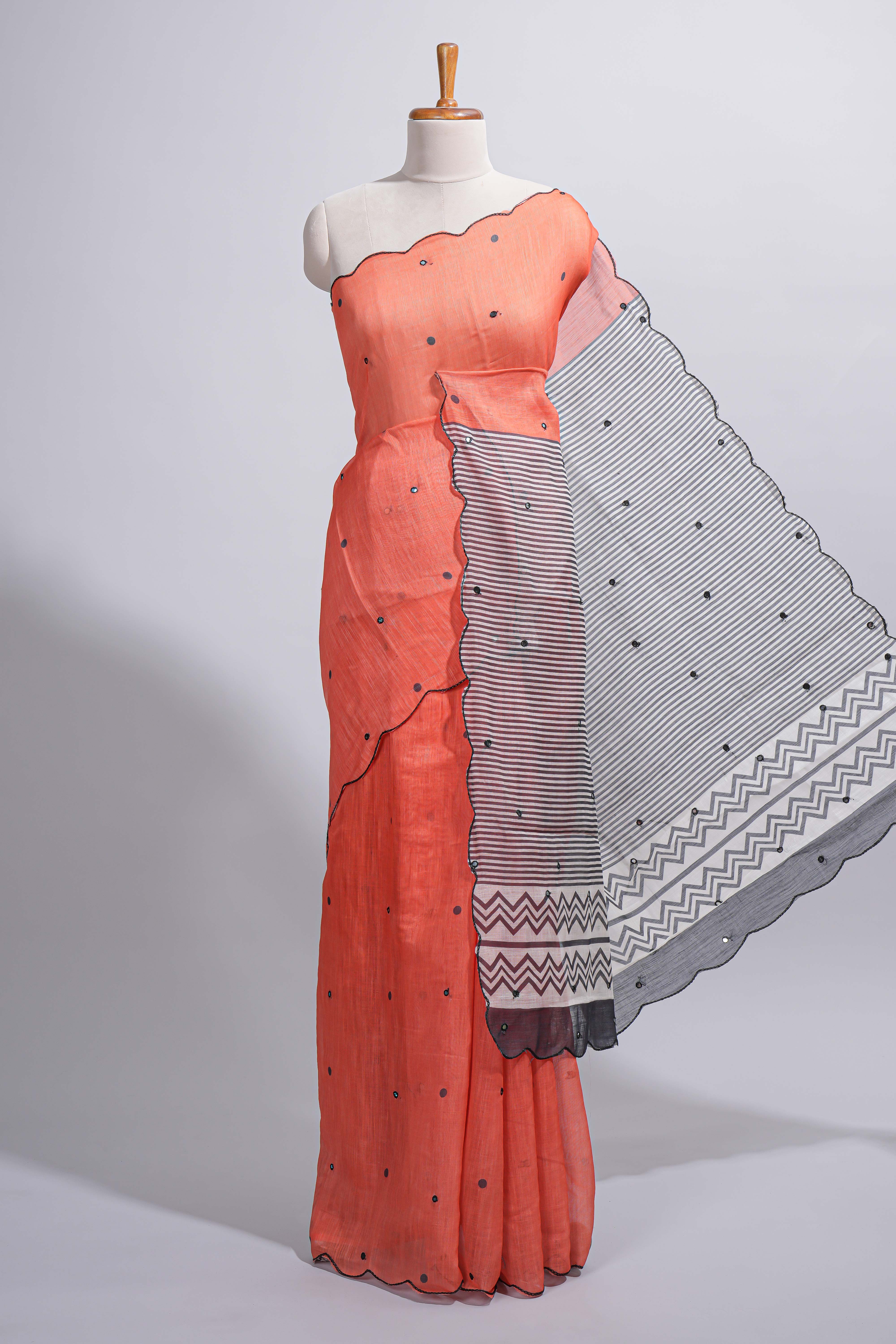 Orange linen cotton saree withsequin details striped and geometric zigzag pallu with scallop border along with striped blouse