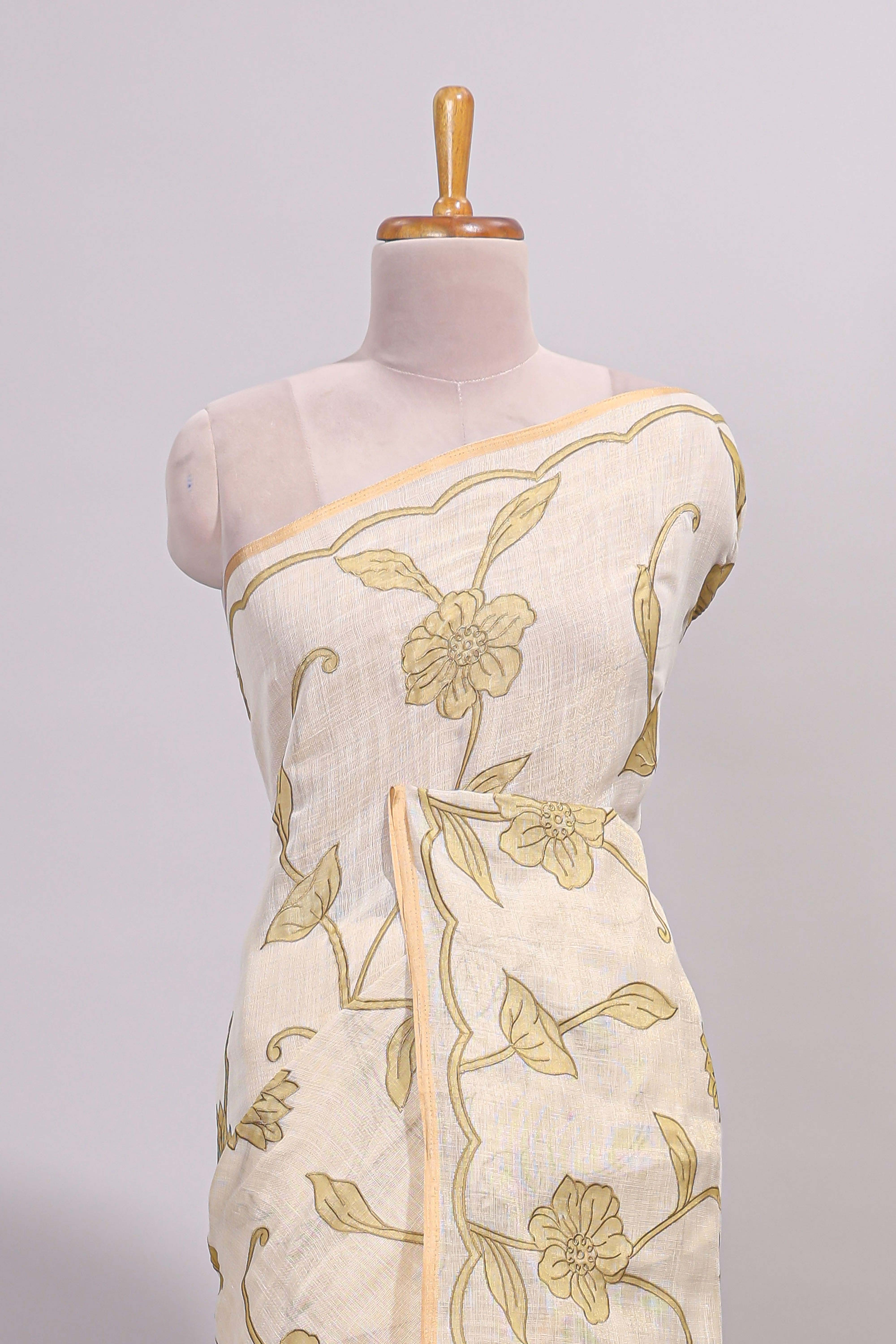 Cream floral design linen cotton saree with self zari border and matching printed blouse