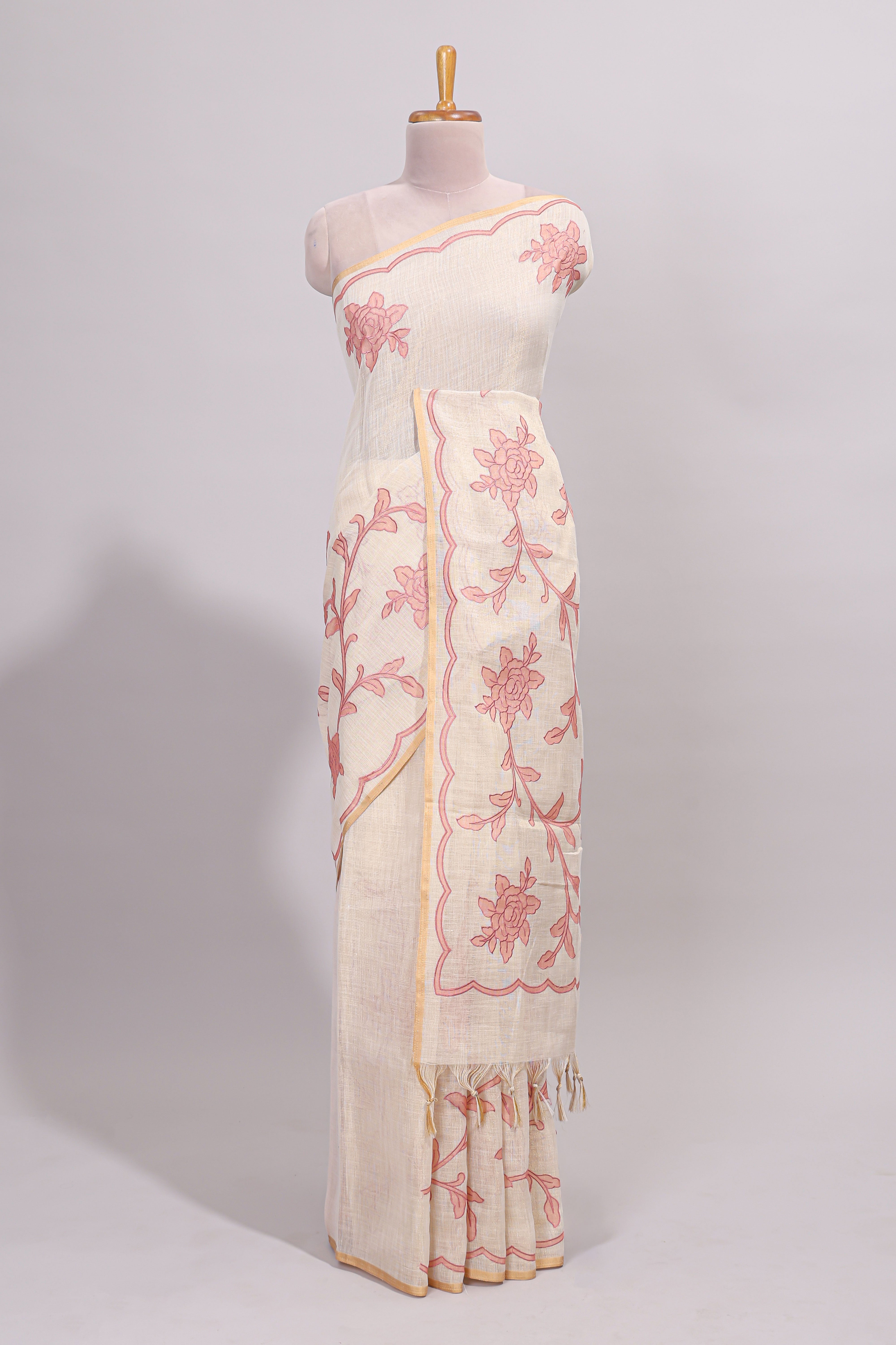 Cream floral design linen cotton saree with self zari border and contrast printed blouse