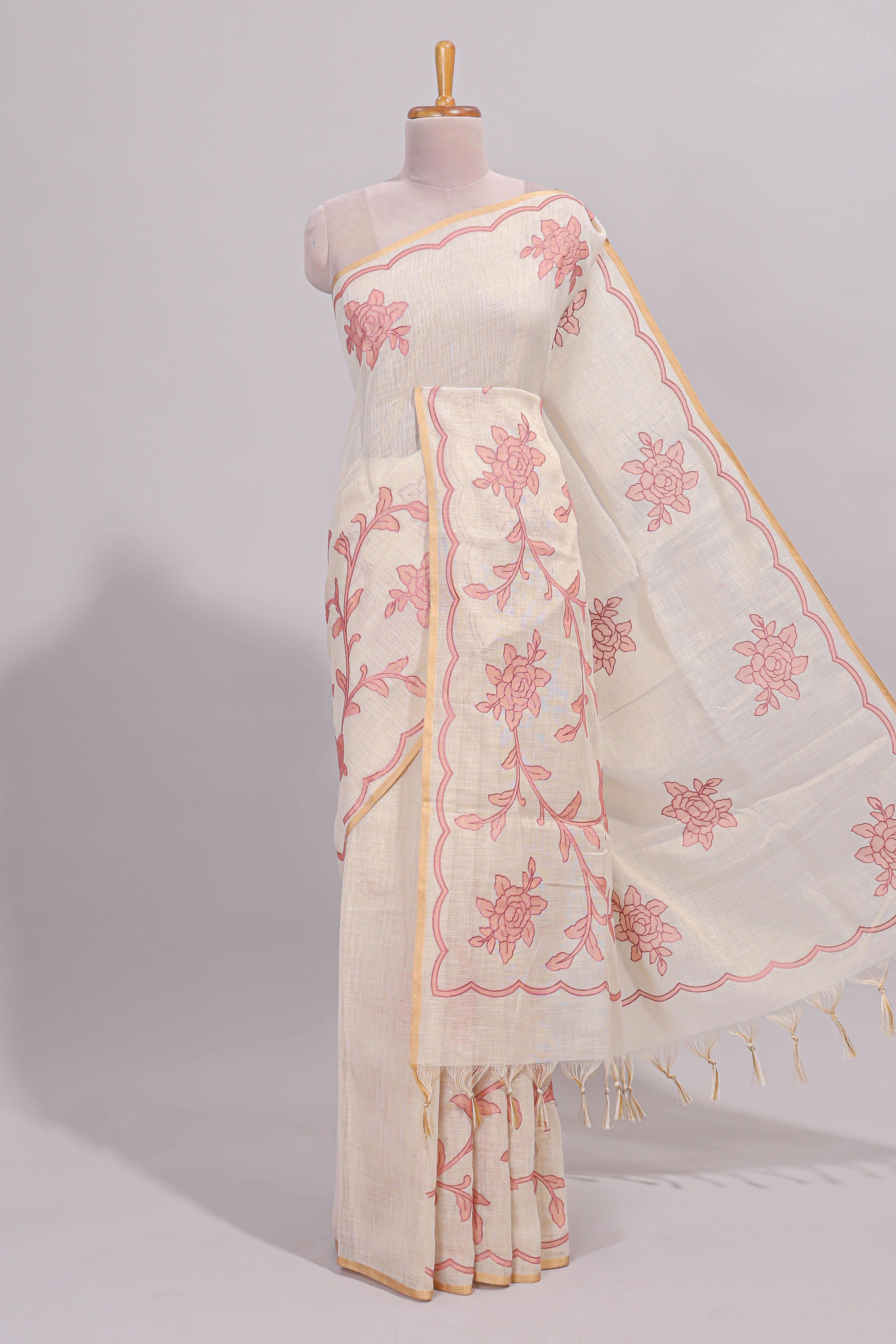Cream floral design linen cotton saree with self zari border and contrast printed blouse