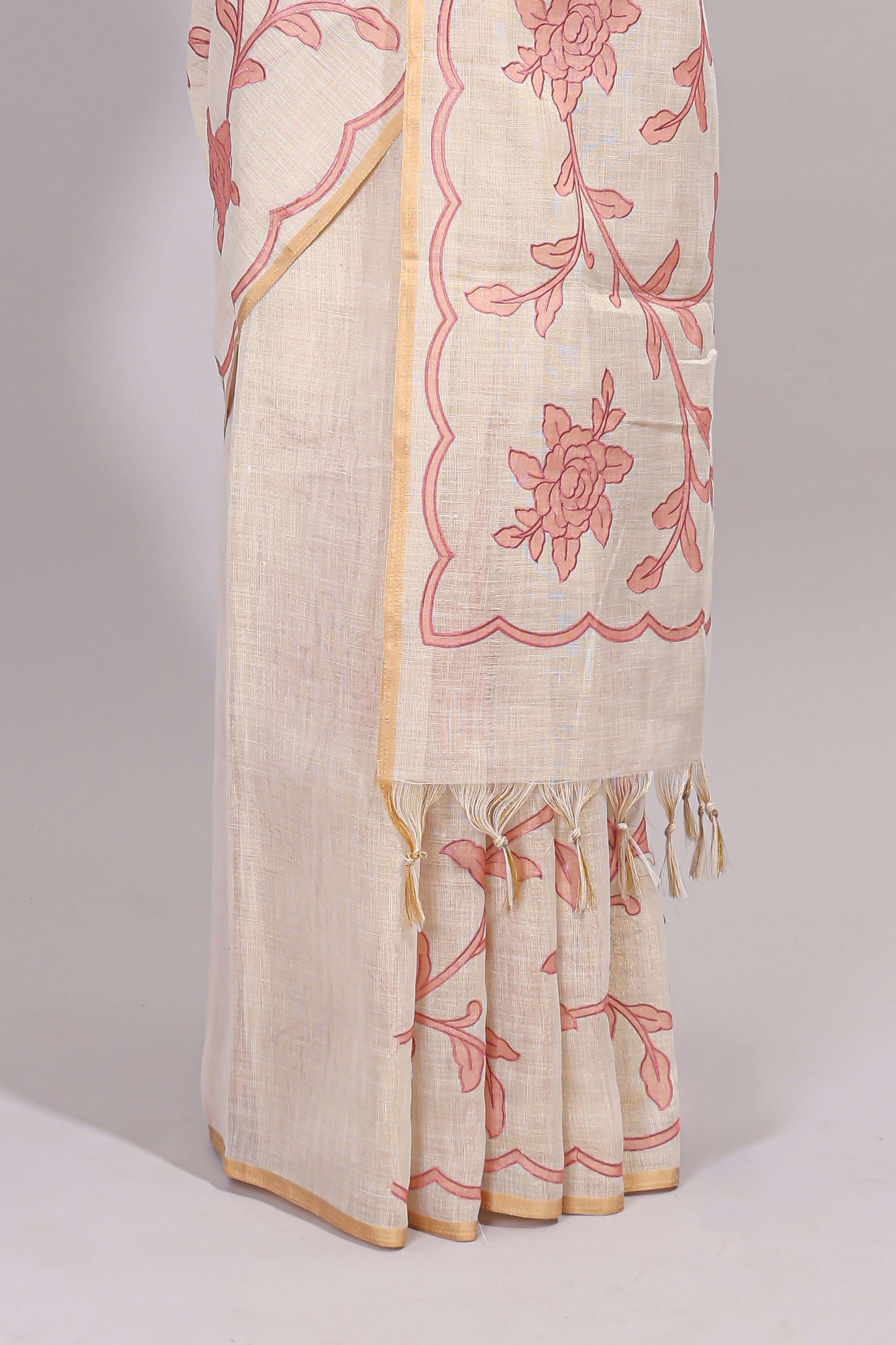 Cream floral design linen cotton saree with self zari border and contrast printed blouse