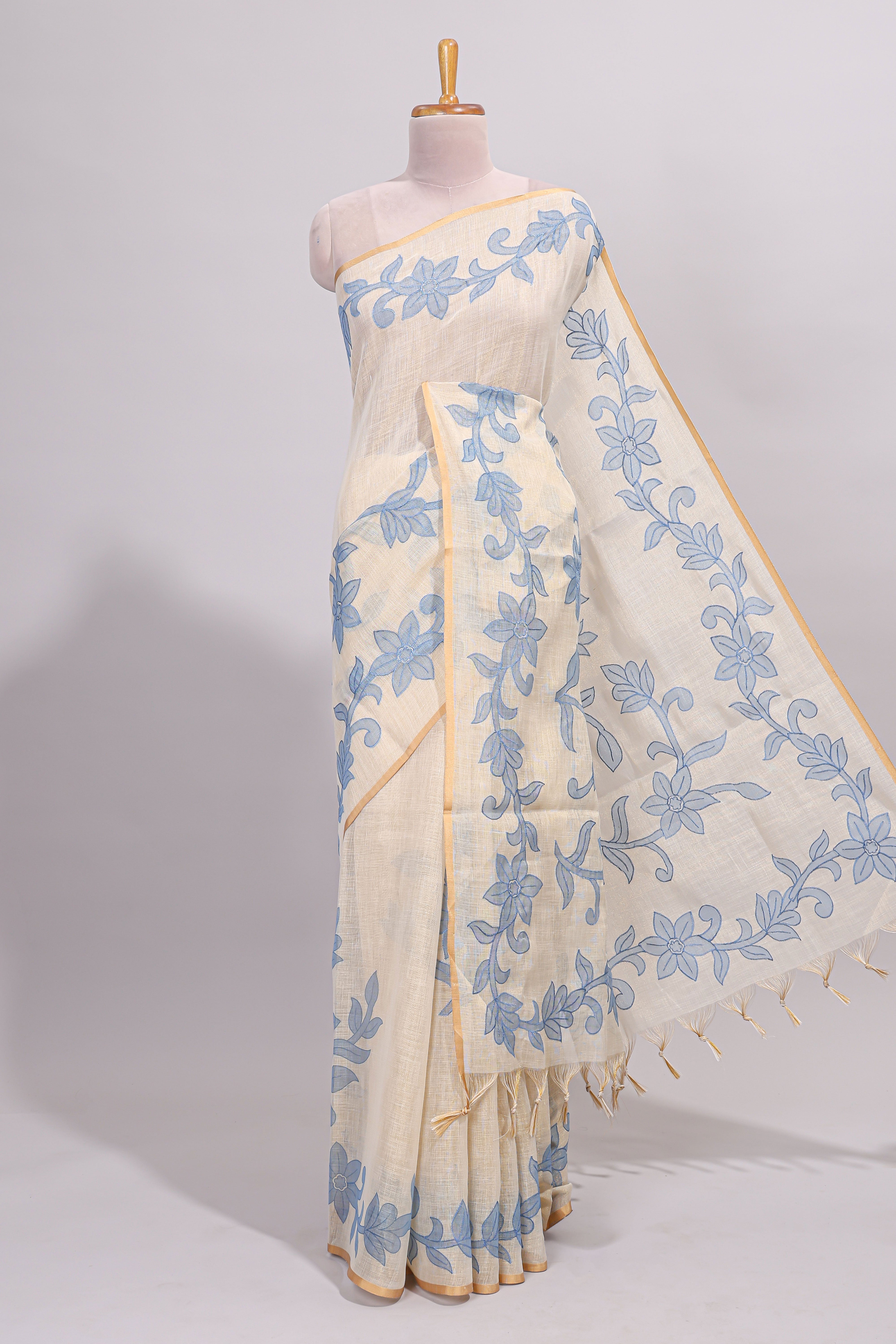 Cream floral design linen cotton saree with self zari border and matching printed blouse