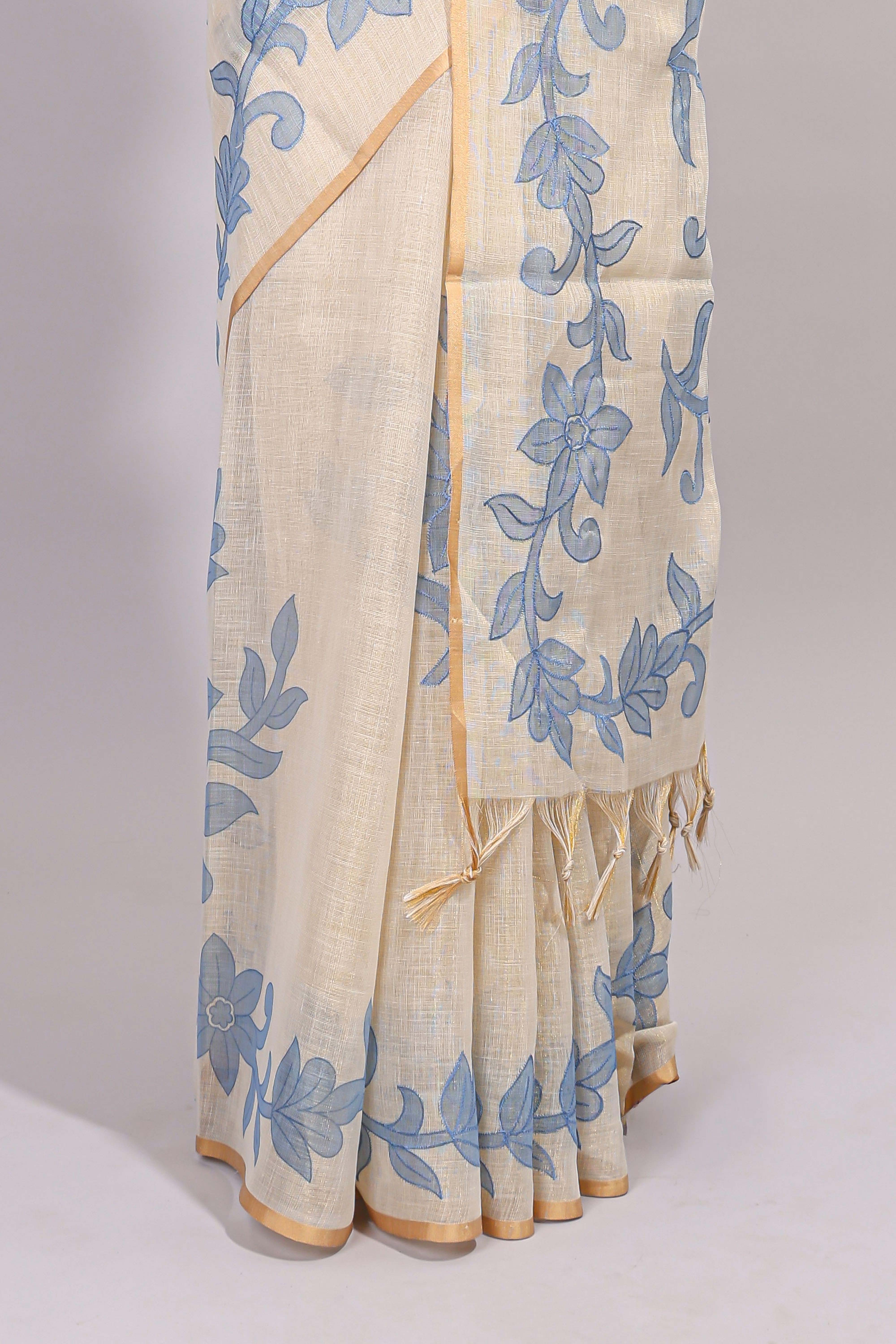 Cream floral design linen cotton saree with self zari border and matching printed blouse